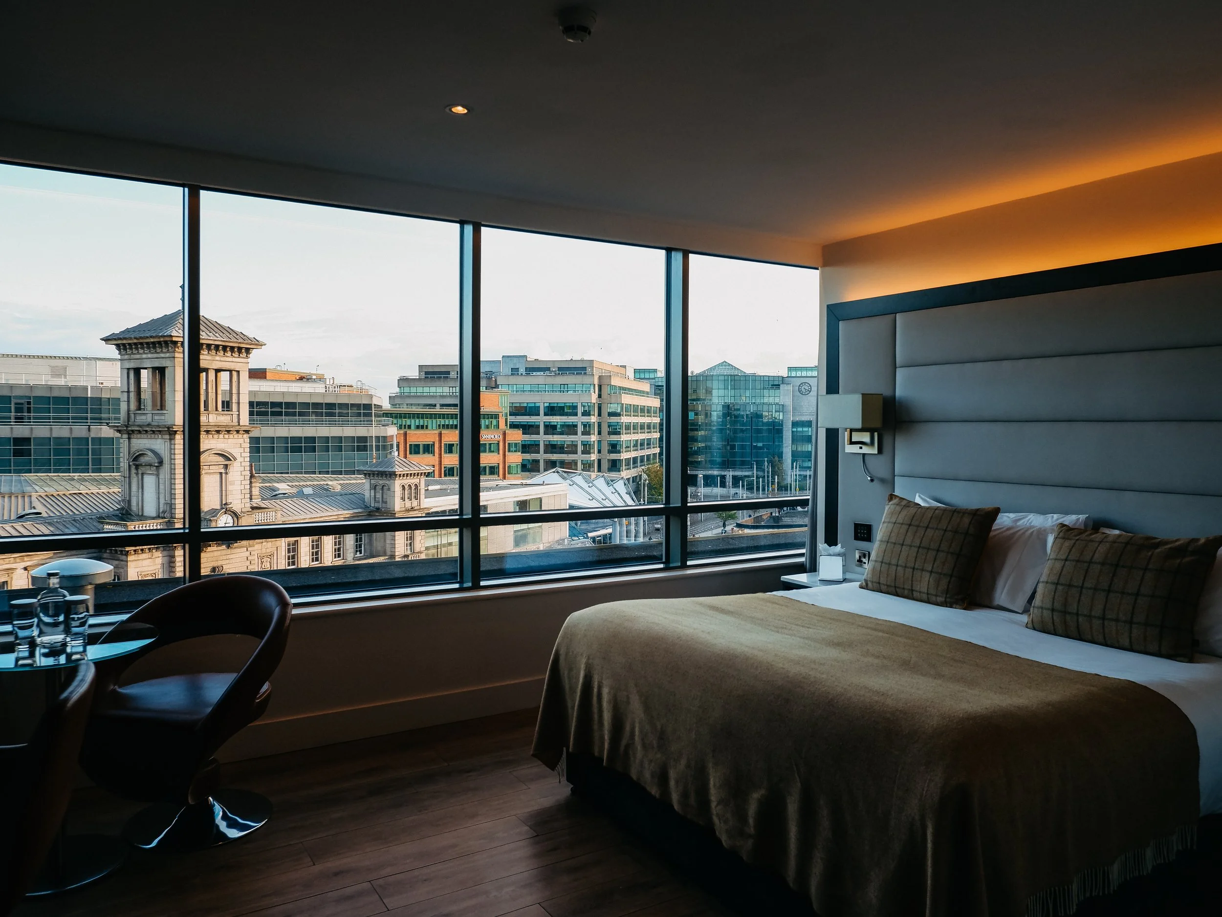 Modern guest room with floor-to-ceiling windows overlooking Connolly Station and central Dublin