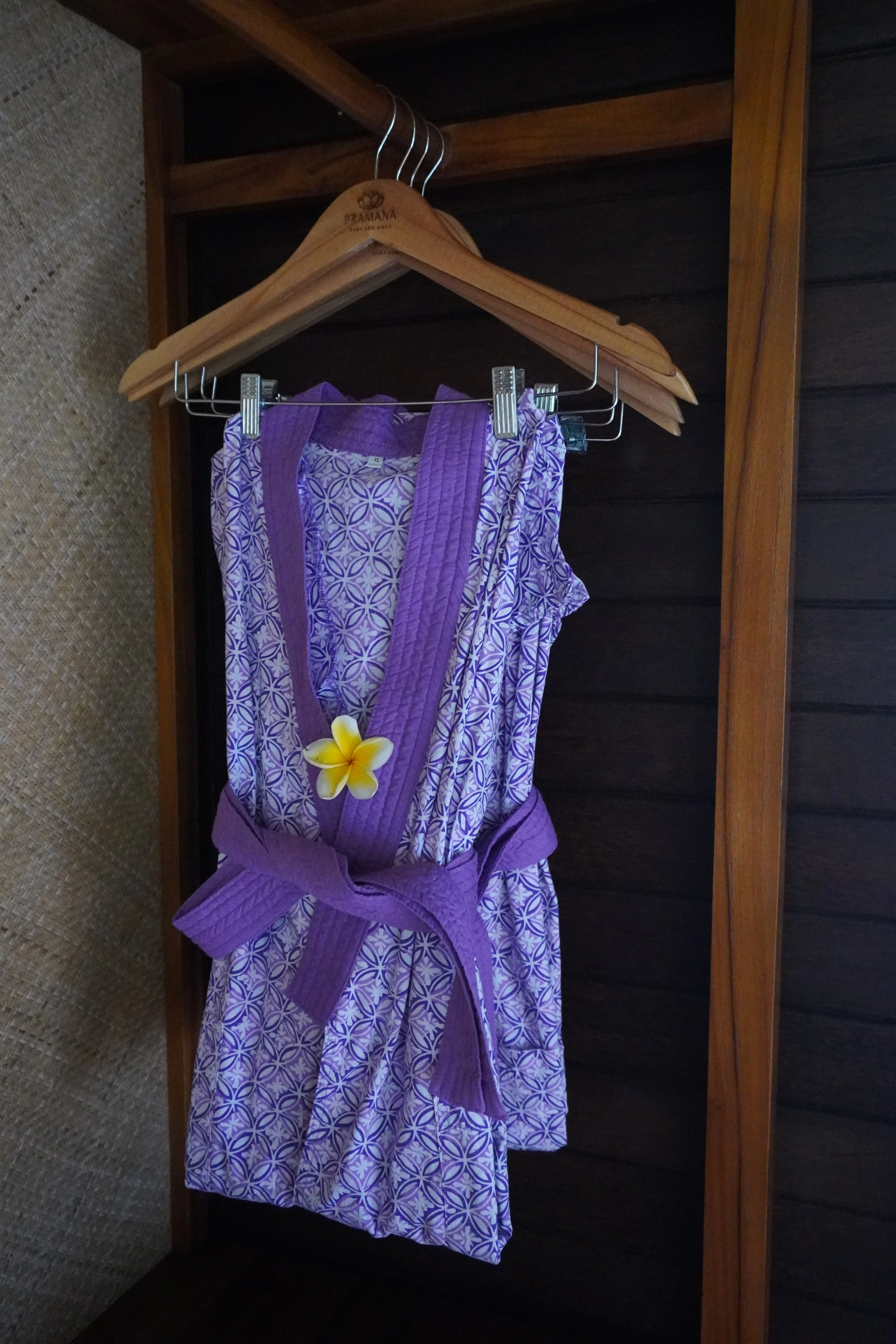 Traditional spa robe prepared with a tropical flower for arriving guests