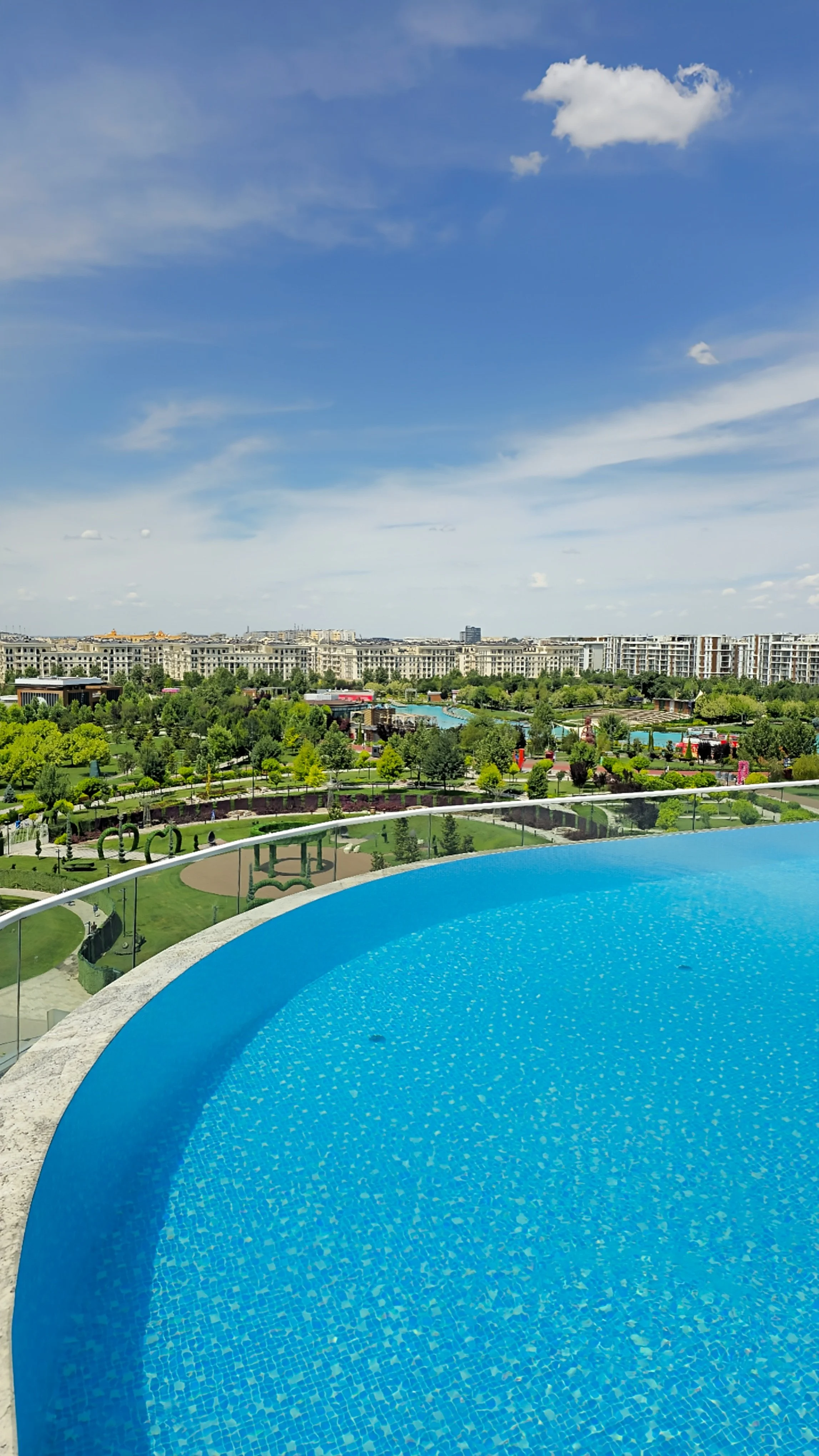 Rooftop infinity pool overlooking Tashkent’s skyline, lush green parks, and panoramic city views