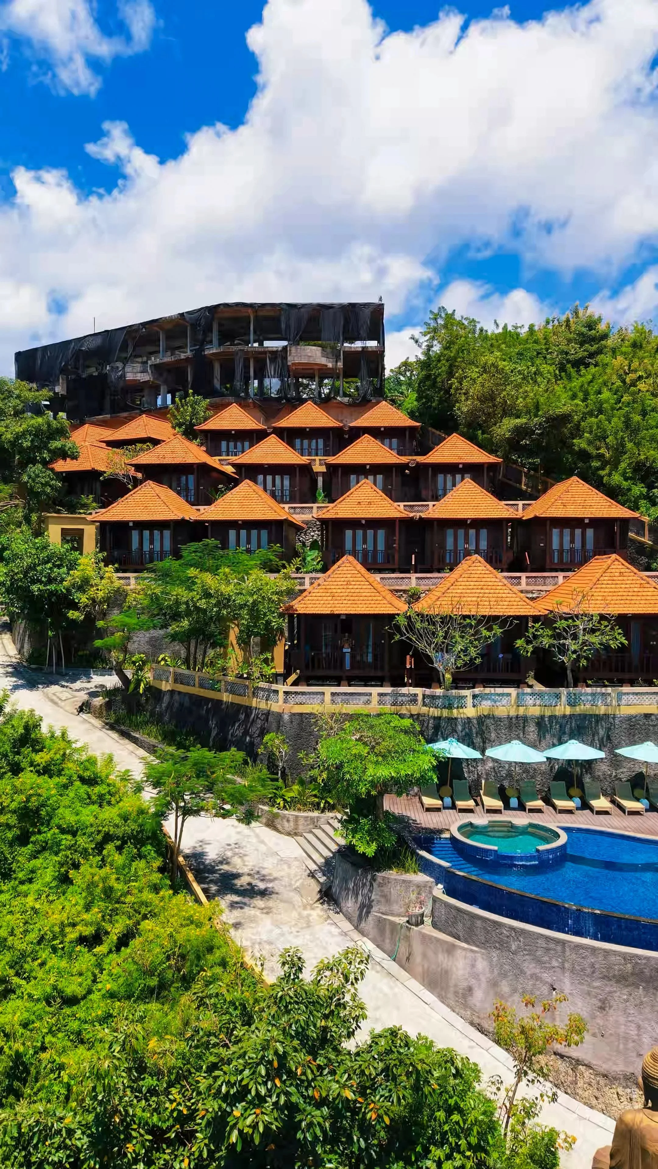 Cliffside boutique resort overlooking the coastline with an infinity pool and tropical gardens