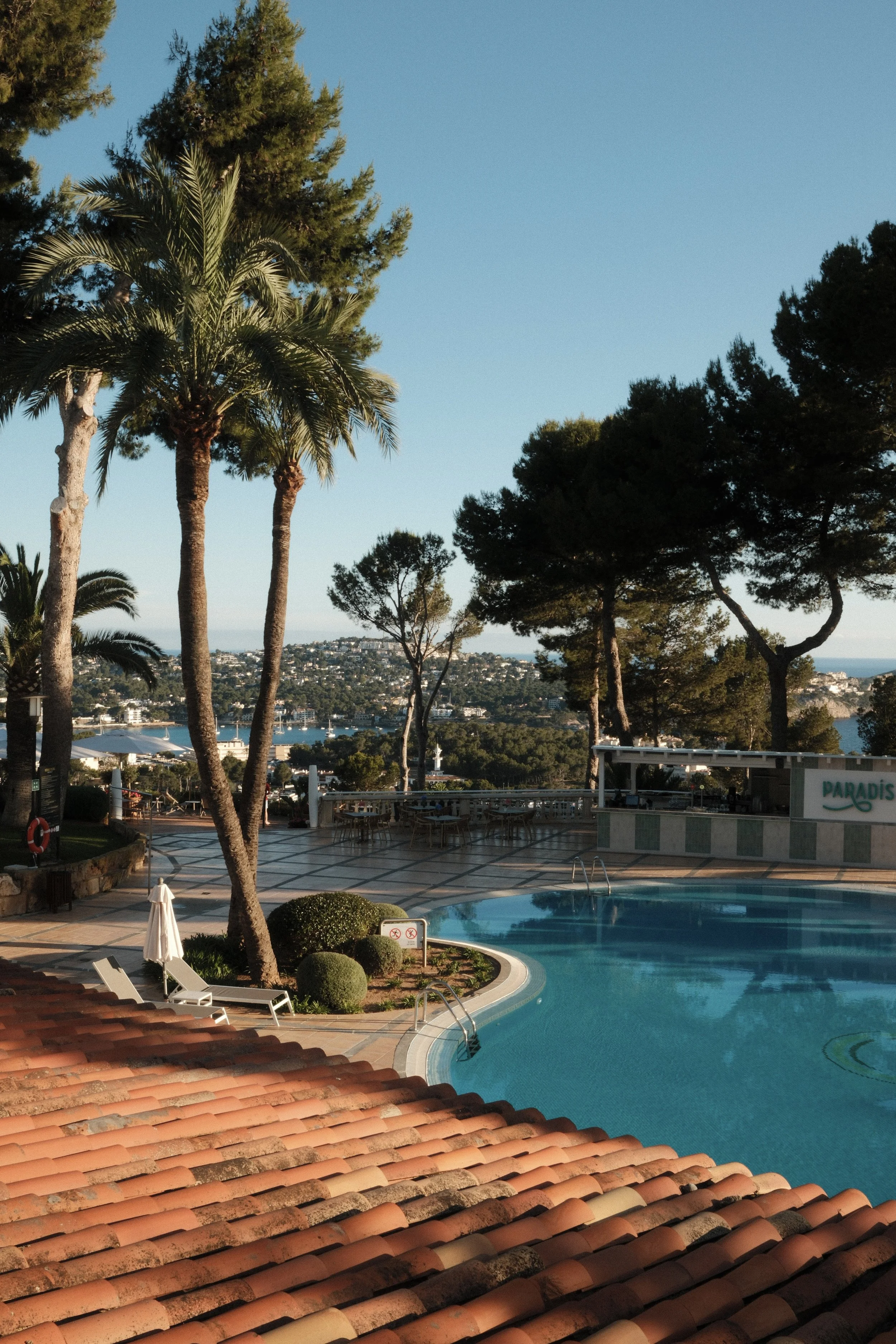 Panoramic pool terrace overlooking the Bay of Santa Ponsa with Mediterranean gardens at Hilton Mallorca Galatzo
