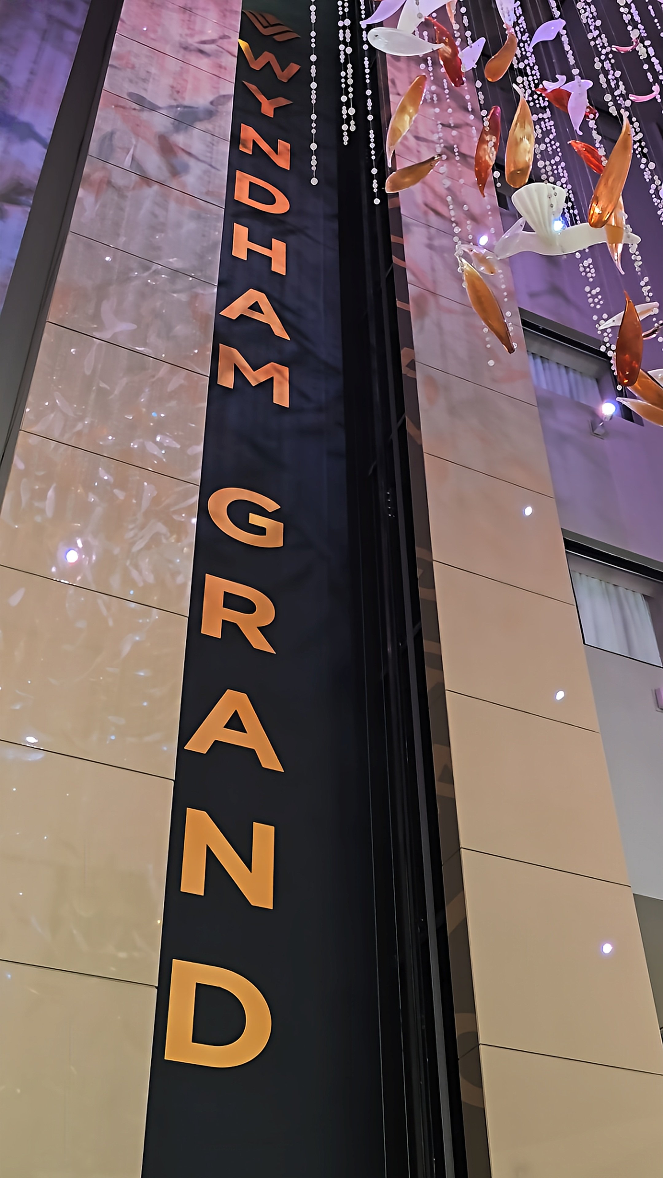 Wyndham Grand interior with illuminated signage and decorative suspended glass sculptures