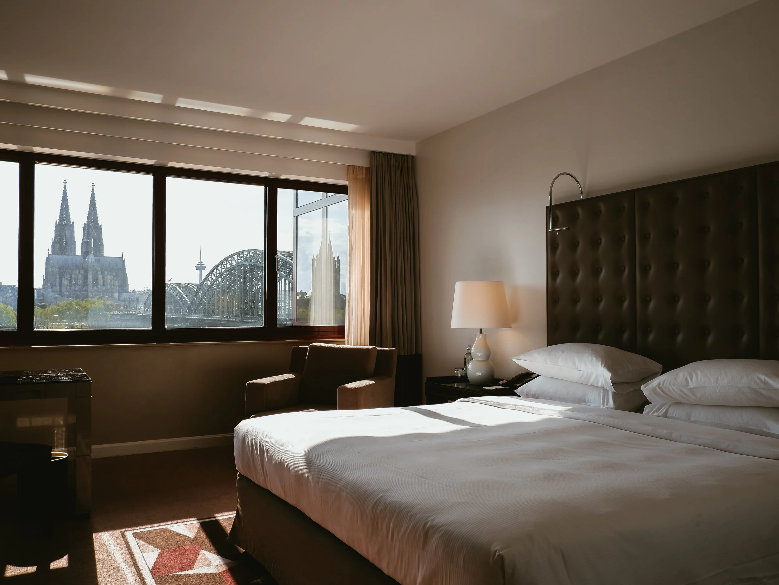 Elegant guest room with panoramic views of Cologne Cathedral and the iconic Hohenzollern Bridge