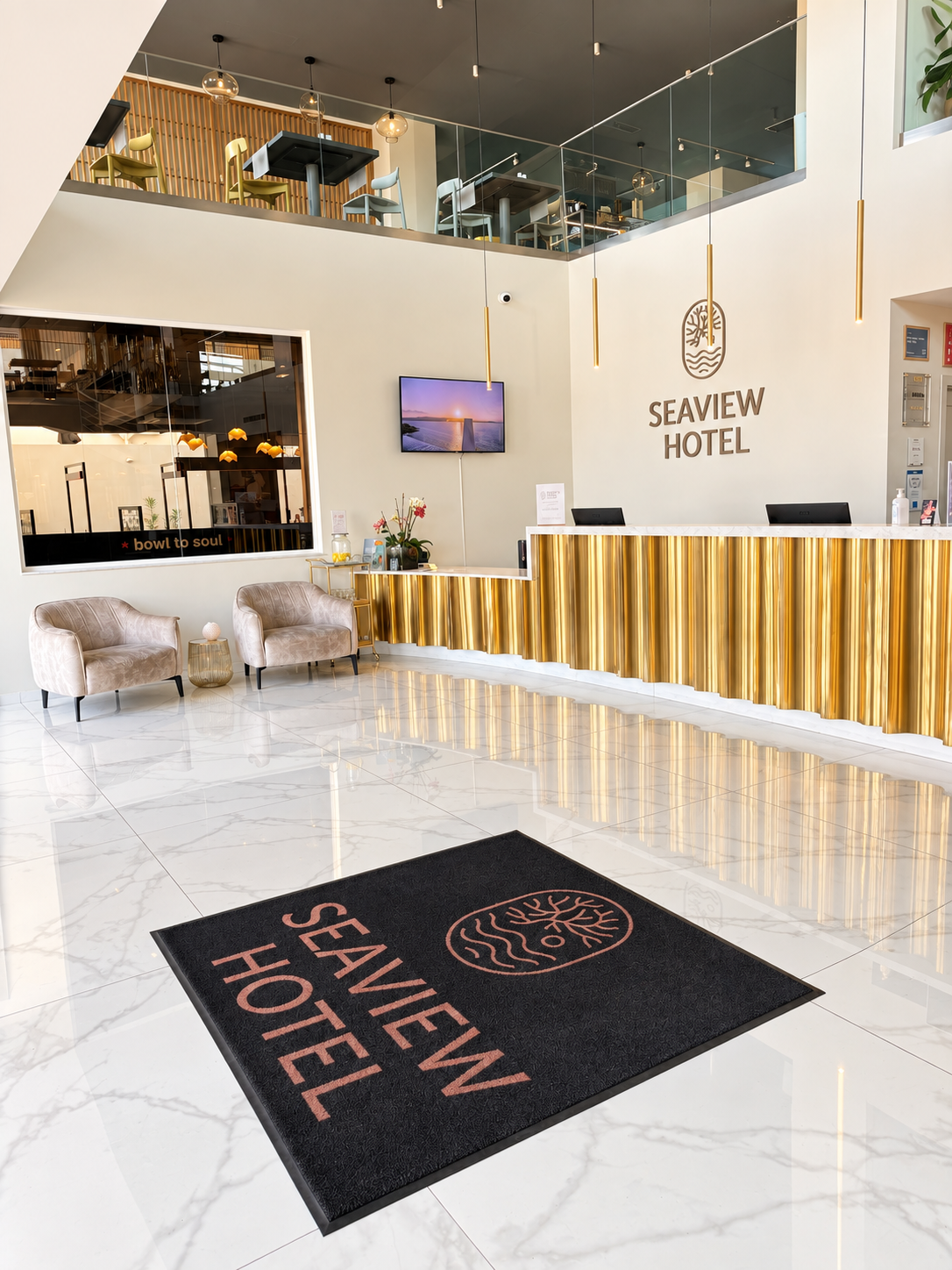 Modern hotel lobby with a gold reception desk, marble flooring, and contemporary lighting