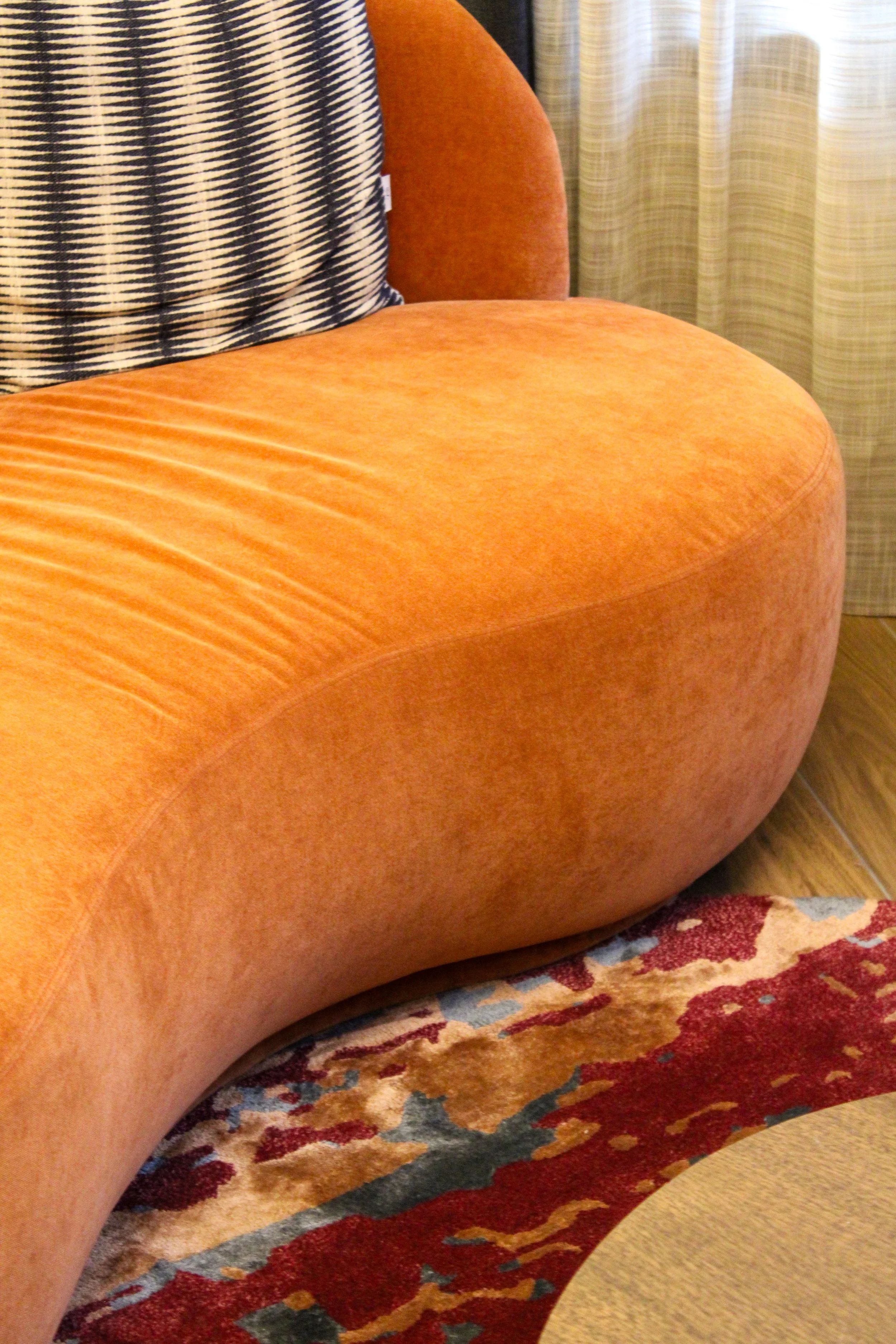 Curved velvet lounge chair with warm contemporary interior design