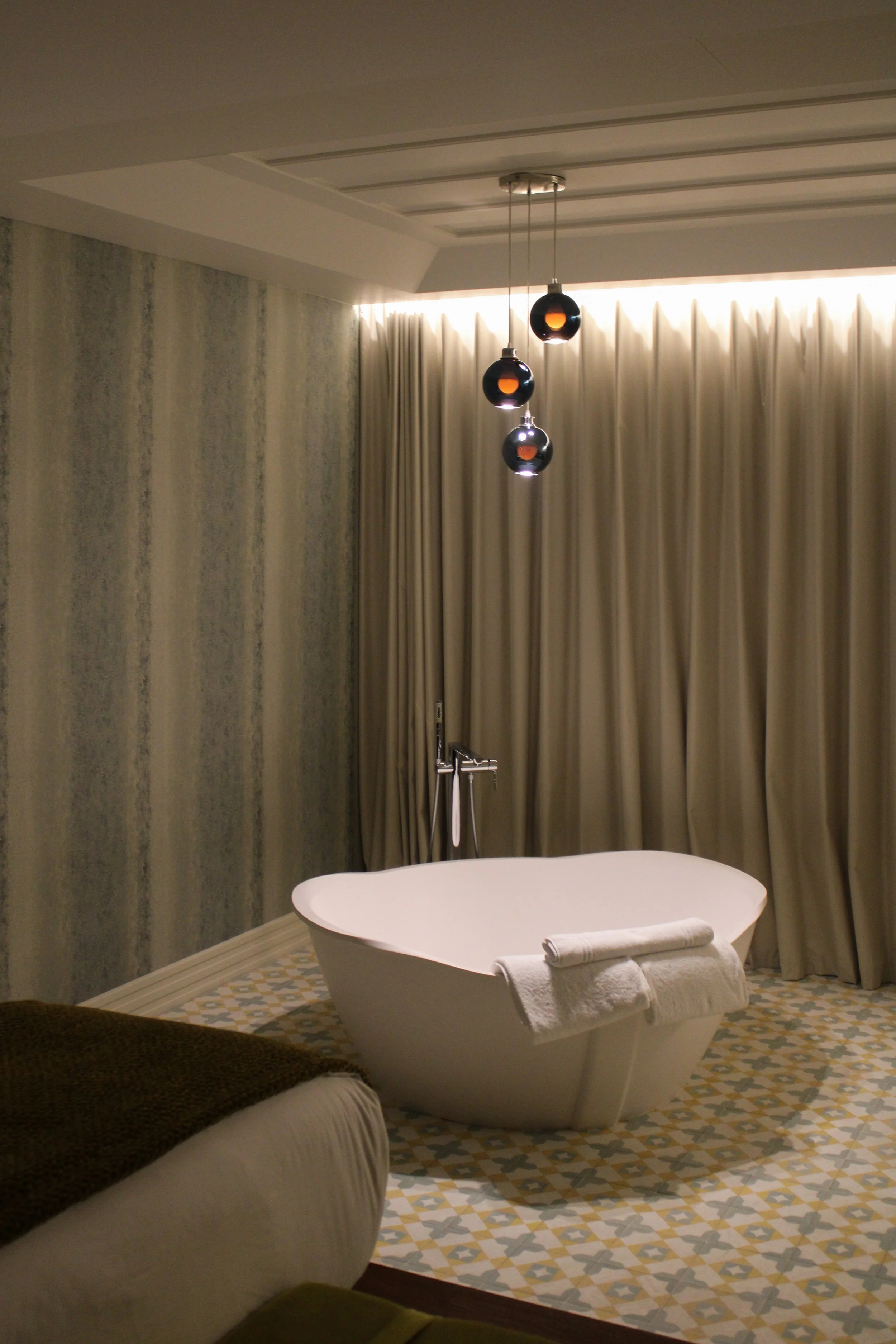 Elegant suite with freestanding bathtub and soft ambient lighting at Convento do Seixo, Portugal