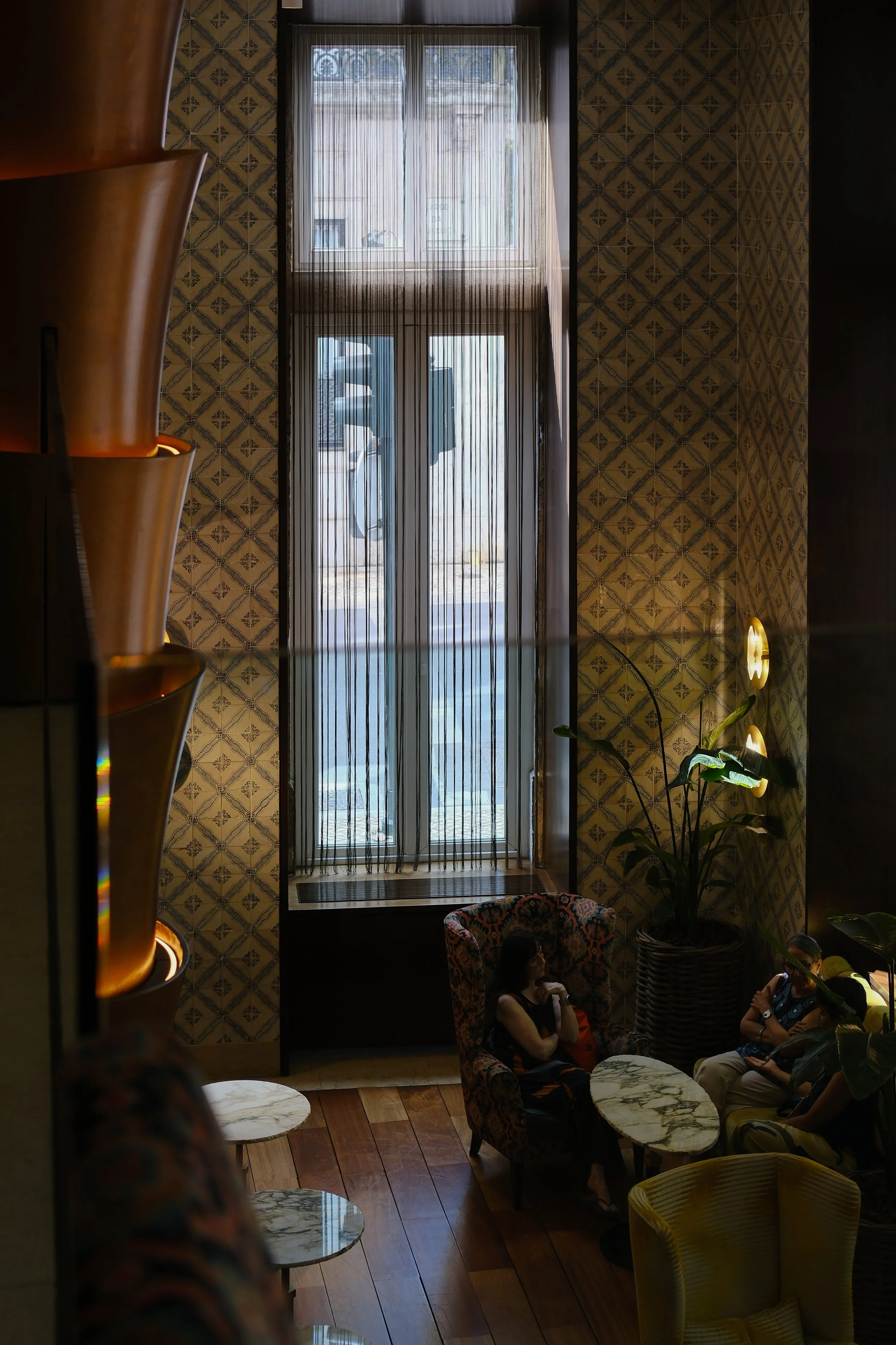 Natural light fills the elegant lounge with traditional Portuguese tile details