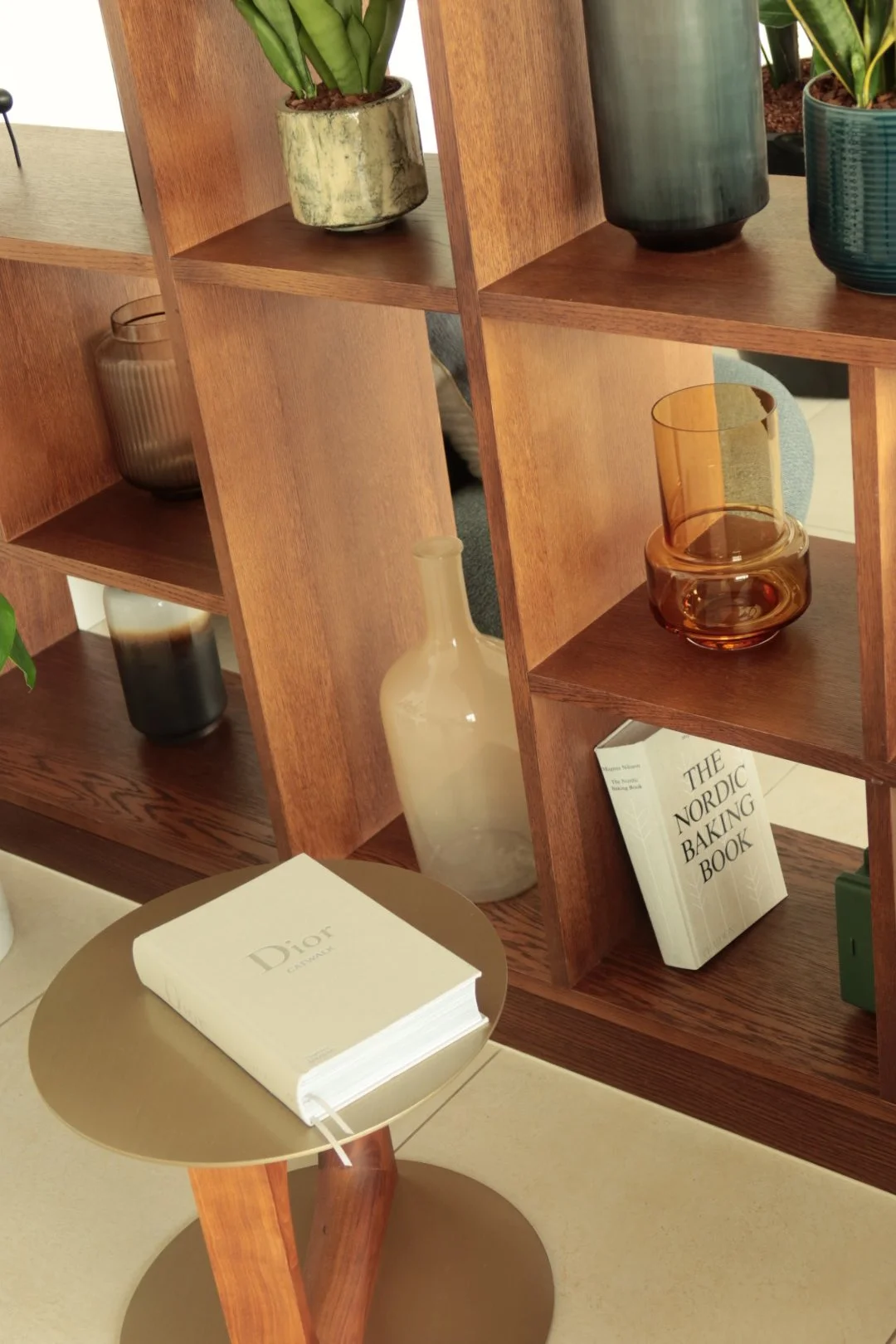 Contemporary lounge shelving with curated décor and warm wood finishes