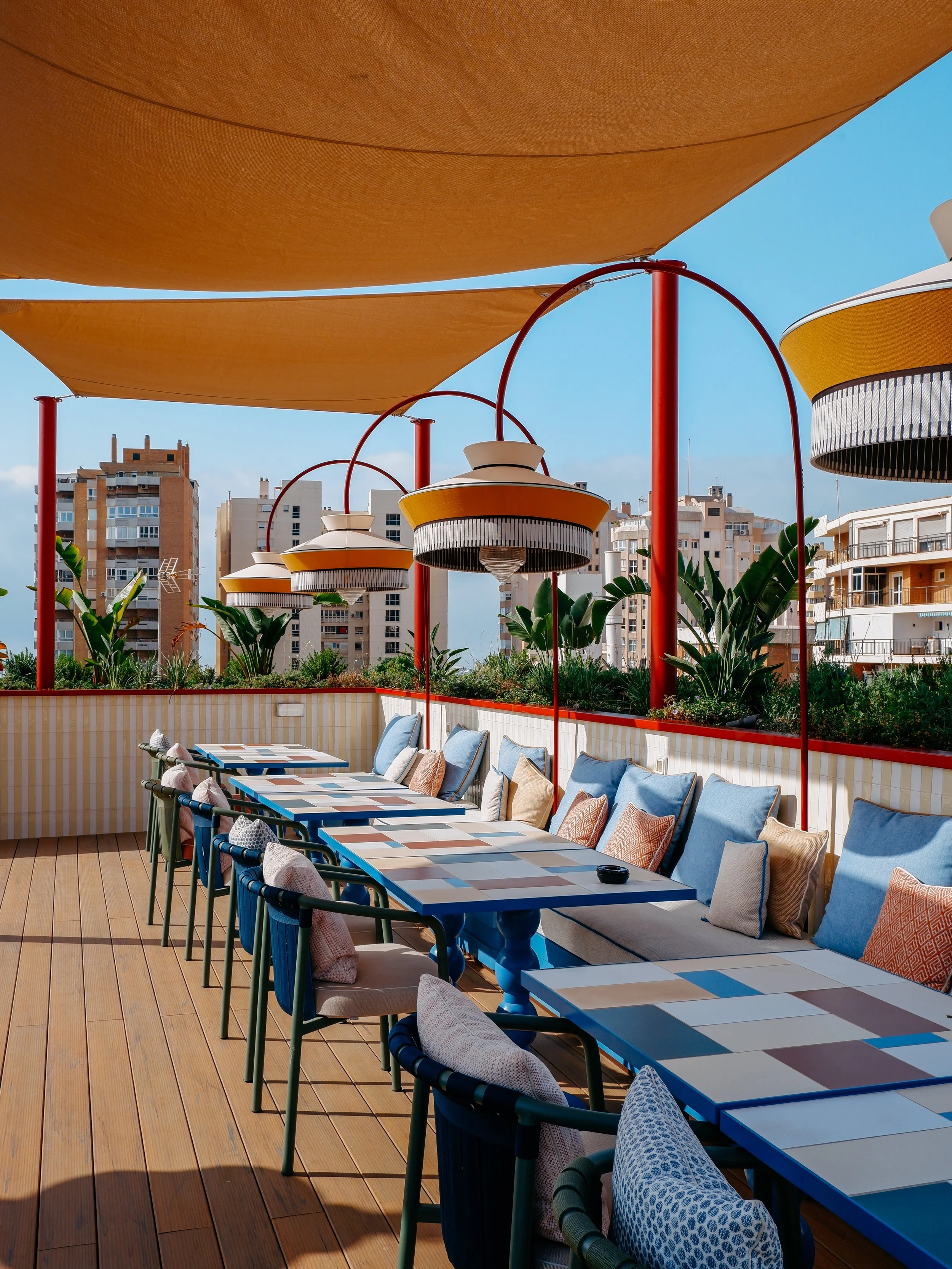 Stylish rooftop terrace with colourful seating and panoramic city views