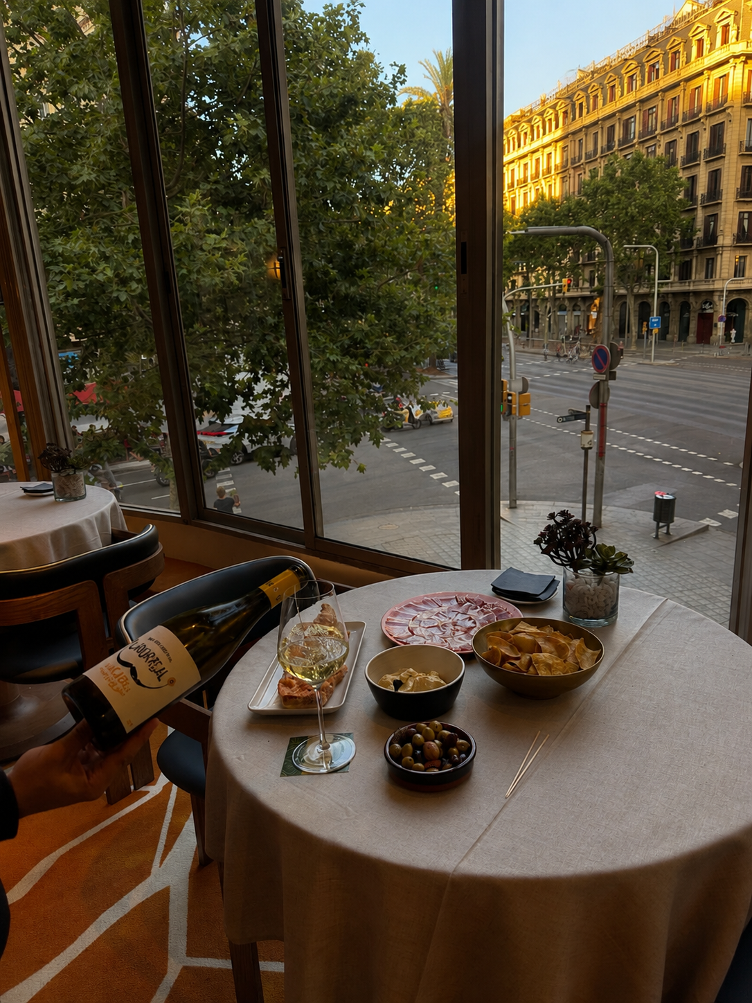 Mediterranean wine and tapas served beside floor-to-ceiling city views