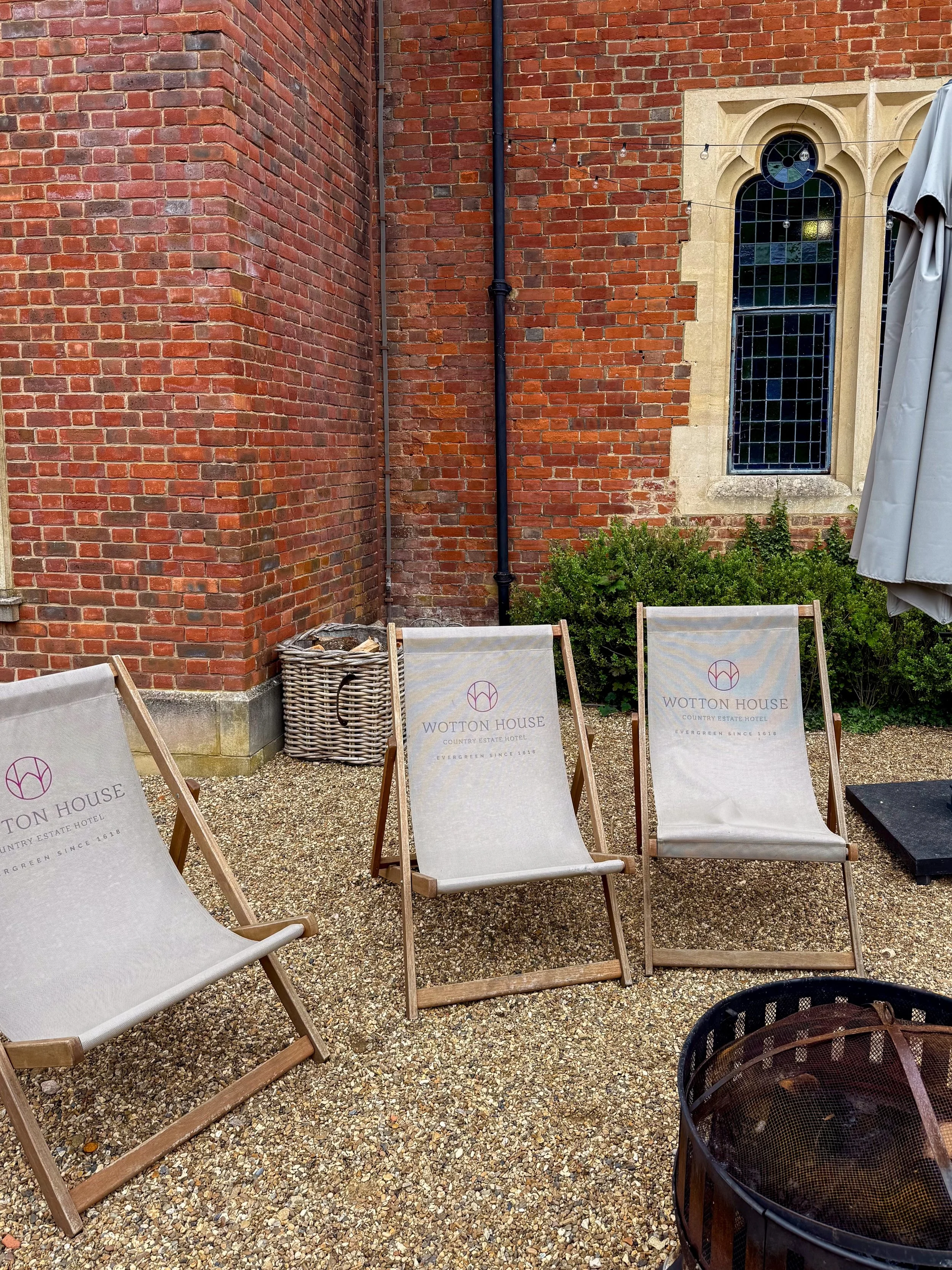 Peaceful courtyard terrace with branded loungers beside the historic estate