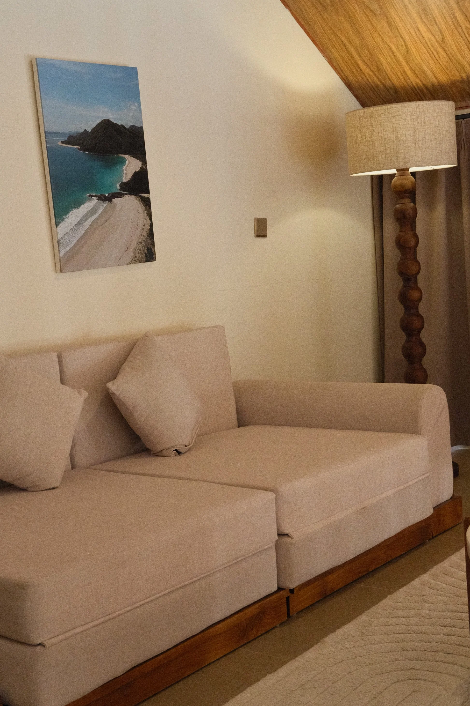 Comfortable living area with soft neutral furnishings and tropical décor