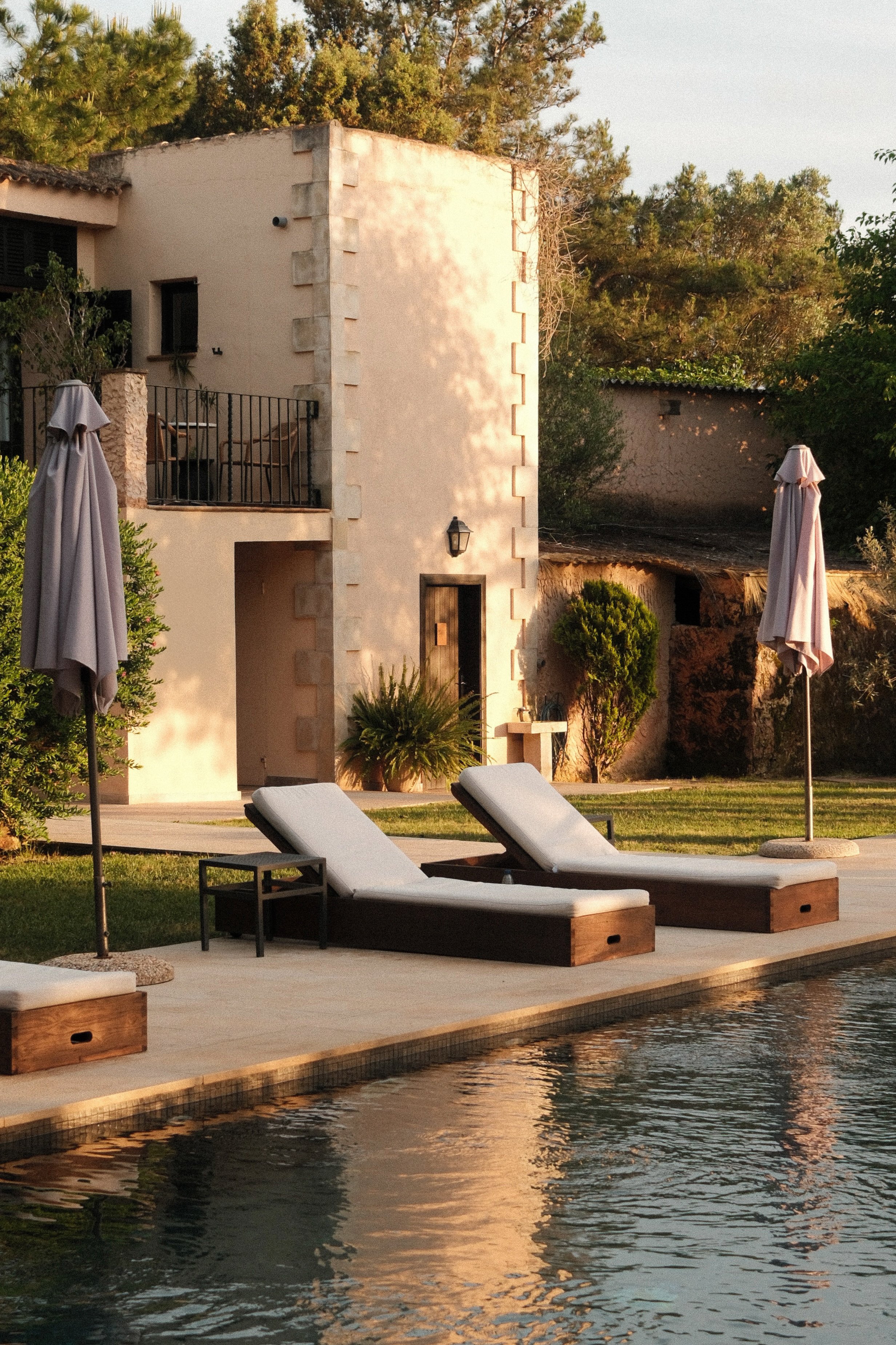 Quiet poolside loungers surrounded by lush gardens at Son Molí Country House in Mallorca