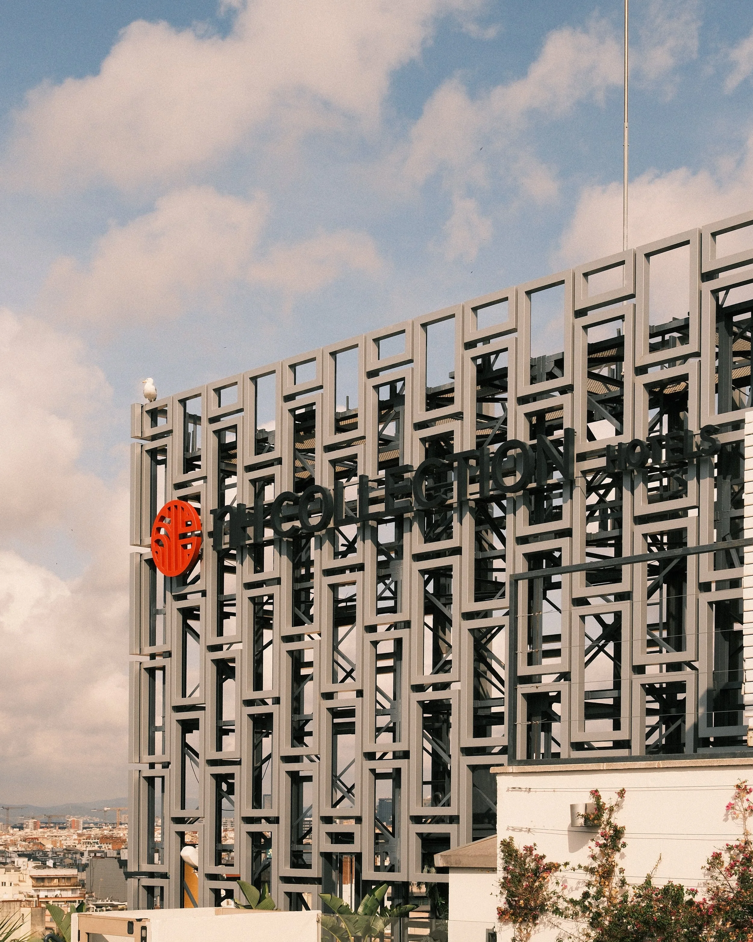 NH Collection rooftop signage overlooking the Barcelona skyline