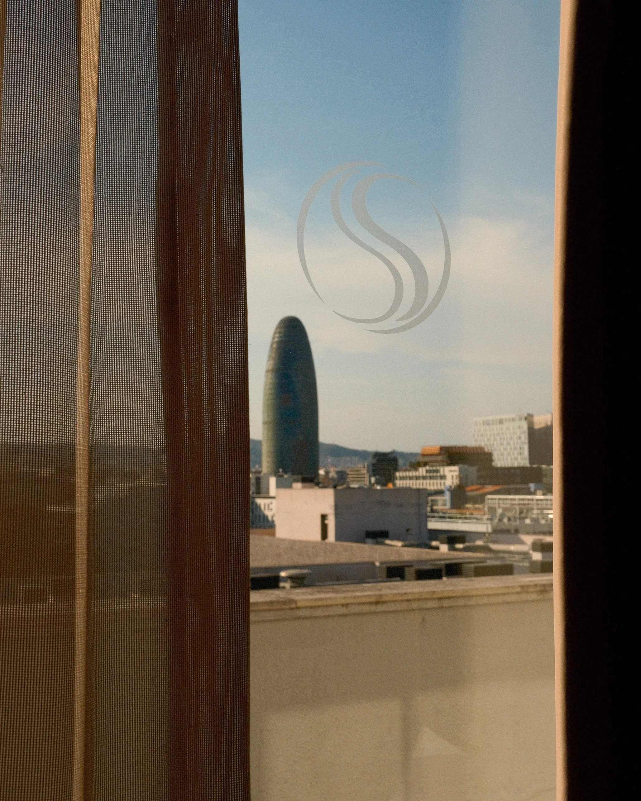 Barcelona skyline framed through the guest room window at Sallés Hotel Pere IV