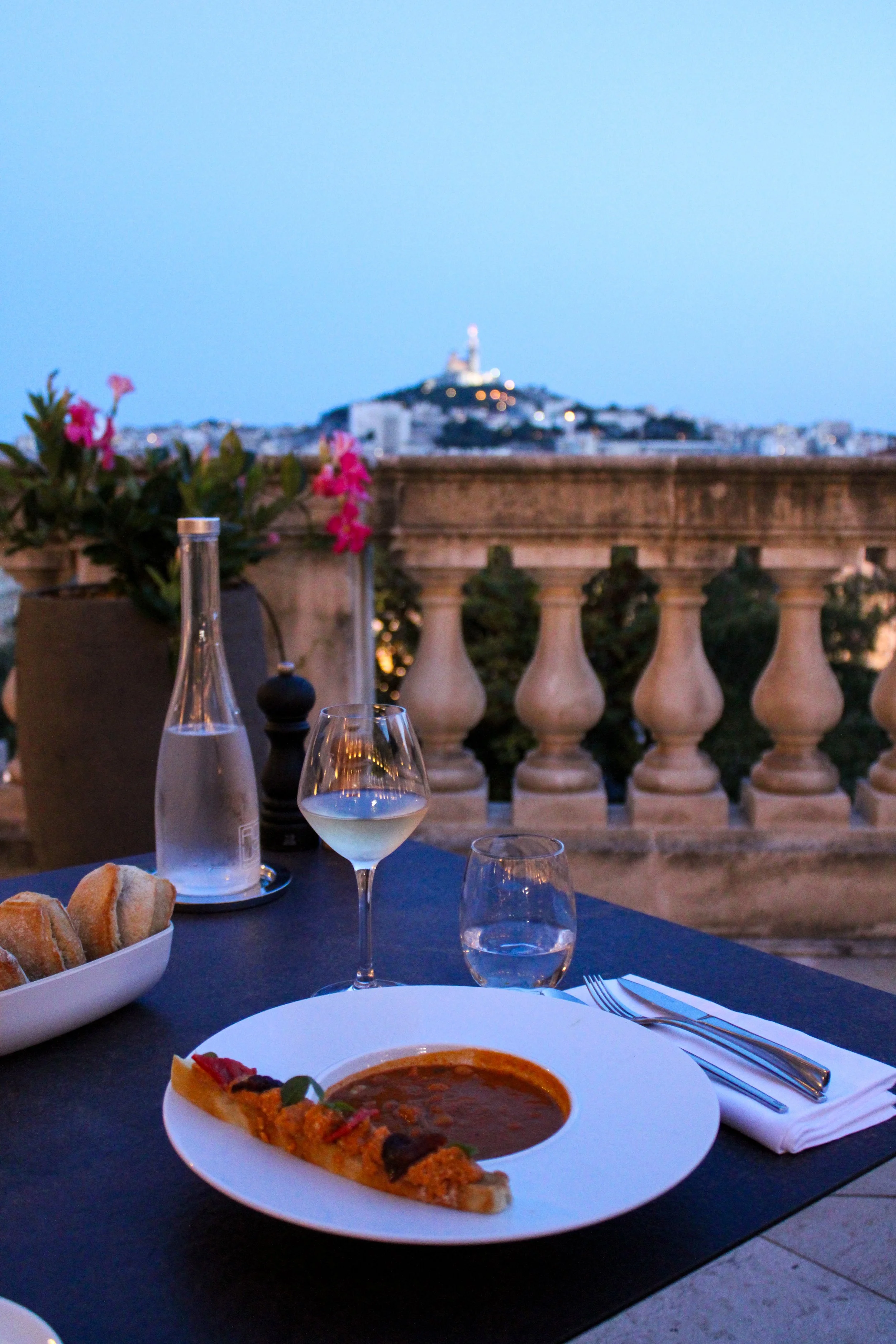 Rooftop dining with panoramic views across Marseille at sunset