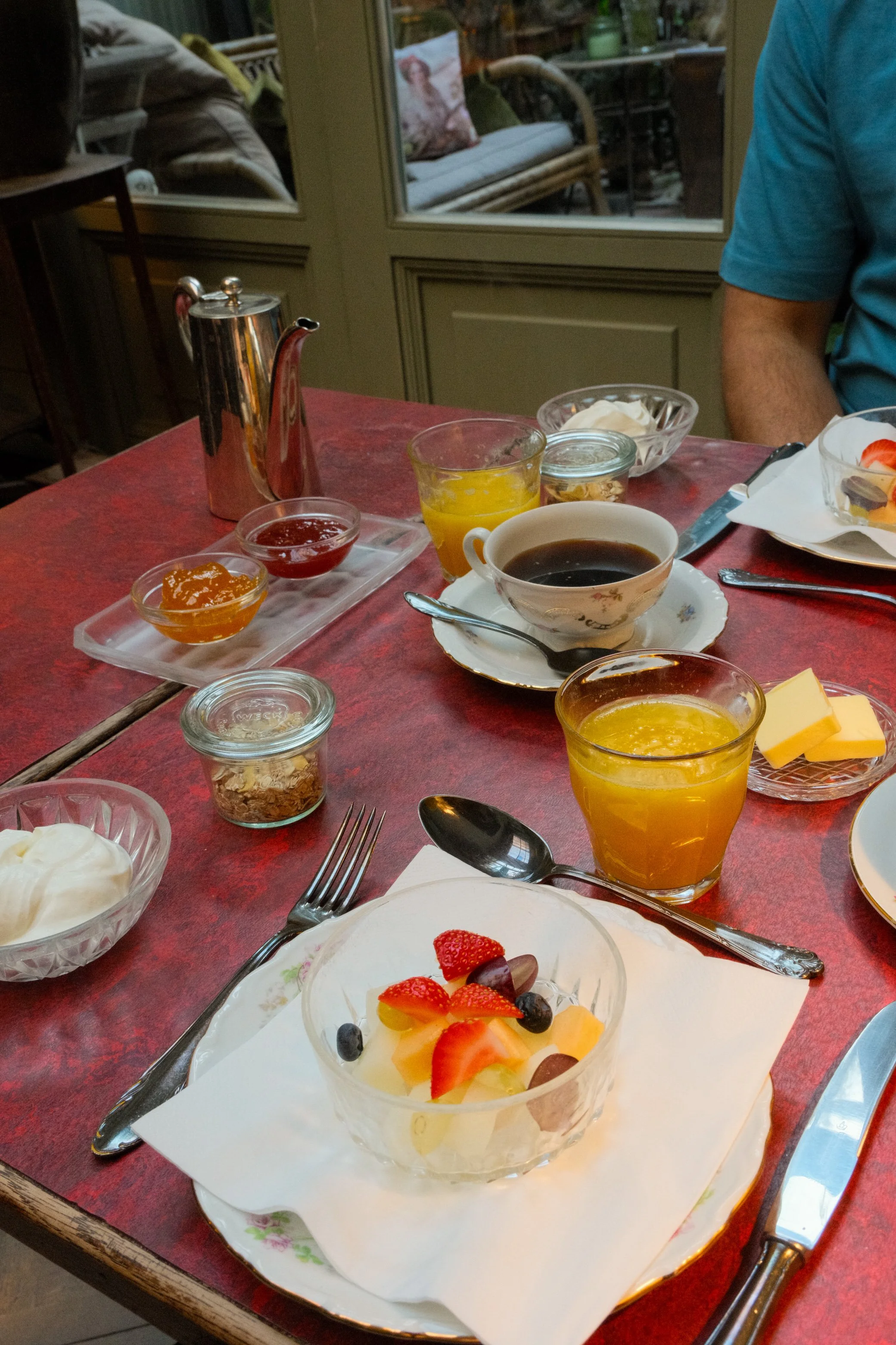 Fresh artisanal breakfast with fruit, coffee, juice, and homemade preserves