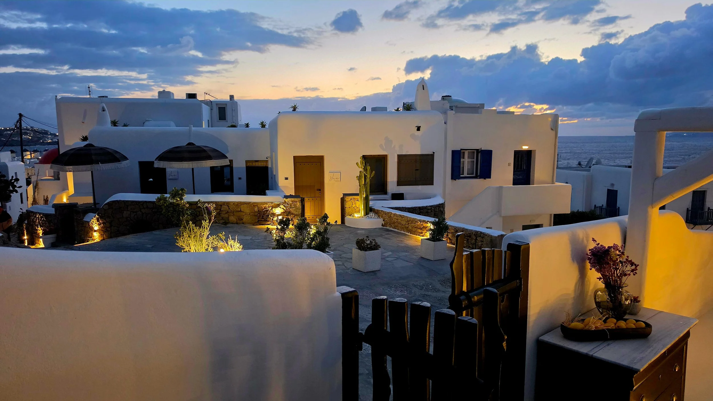 Cycladic-style pathways and sunset views overlooking Mykonos at She Mykonos Hotel, Greece
