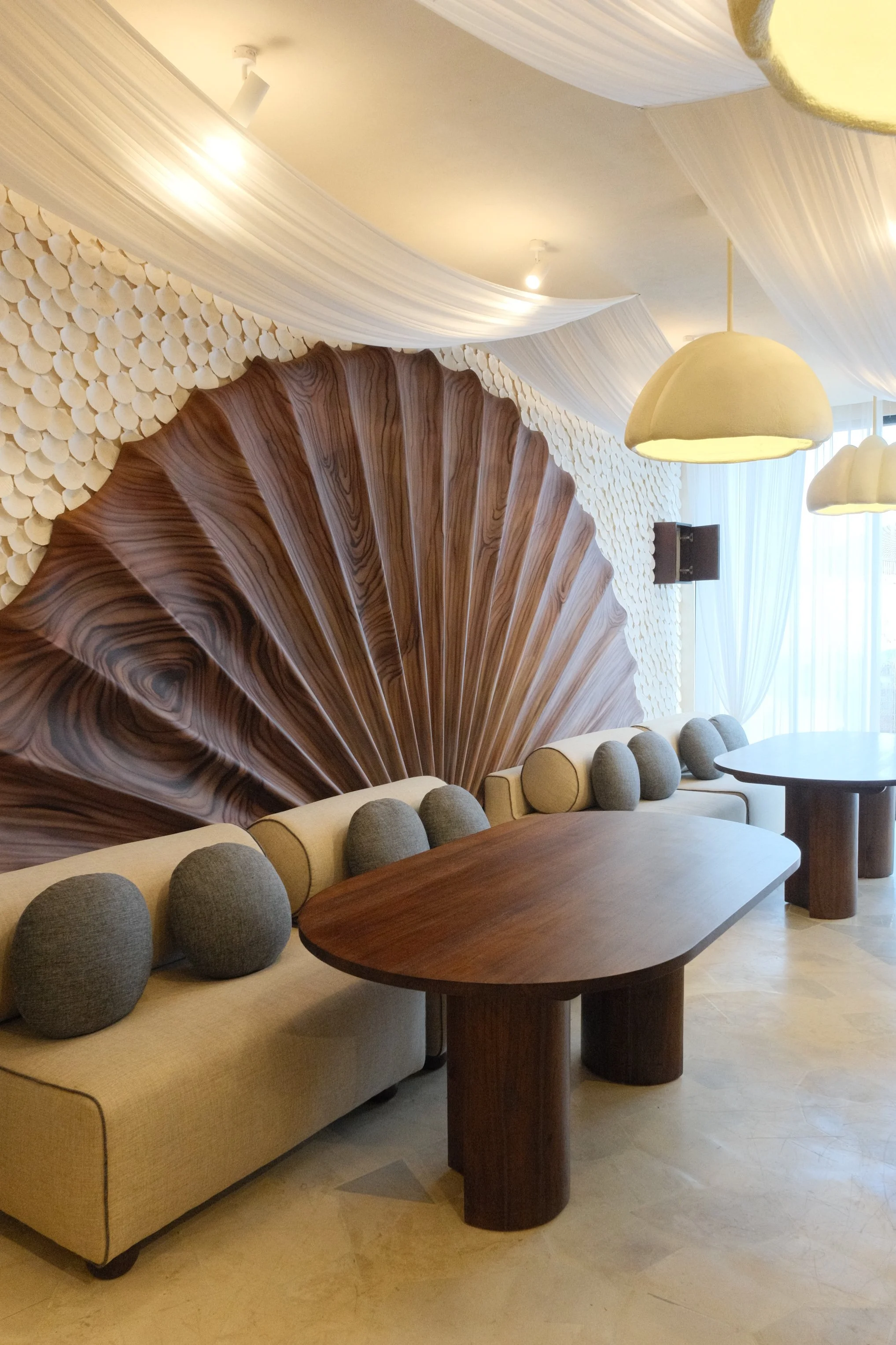 Stylish restaurant featuring sculptural interiors inspired by seashells and coastal design