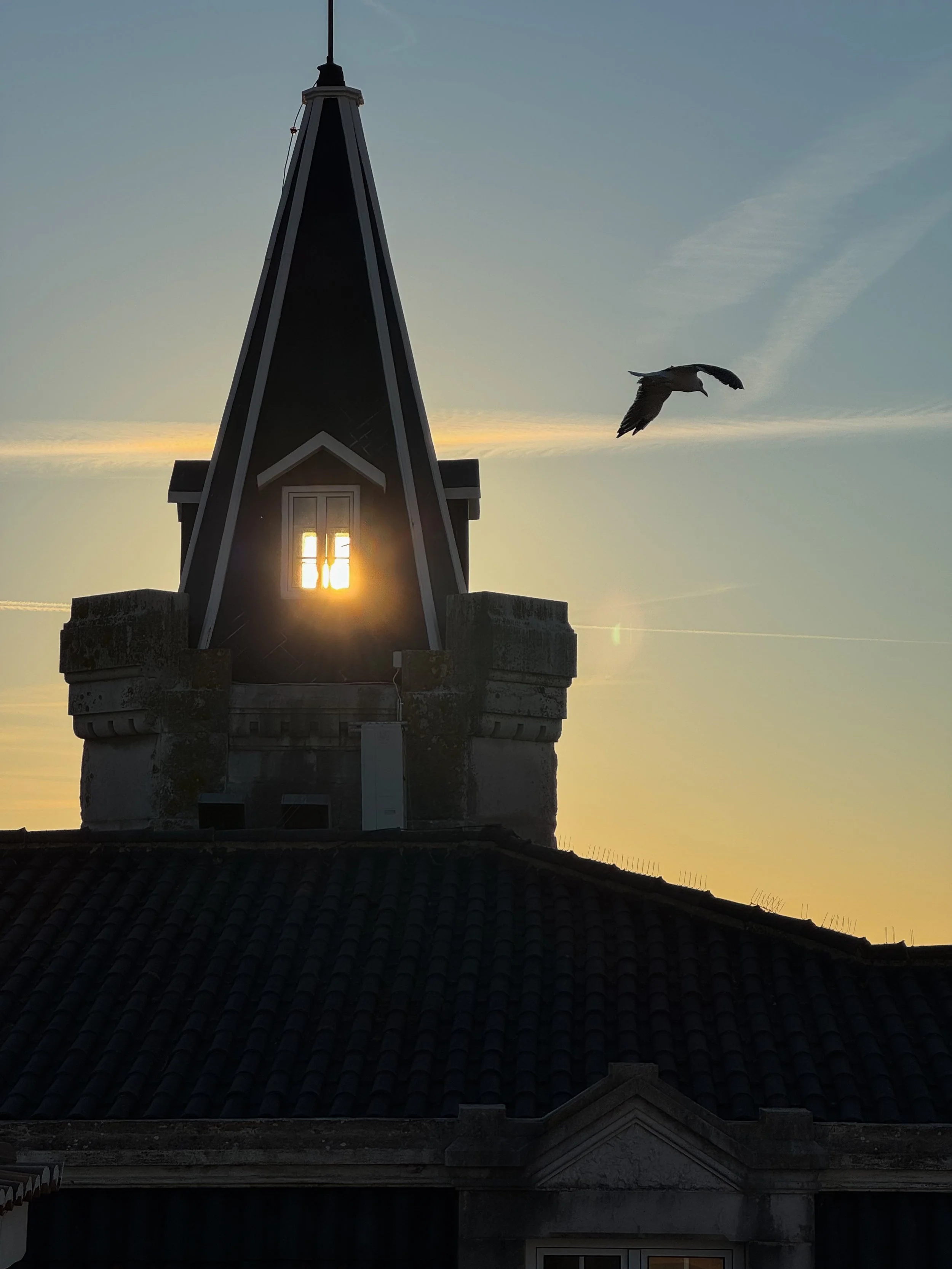 Sunset view over the historic tower and Cascais Bay captured from Villa Cascais Boutique Hotel