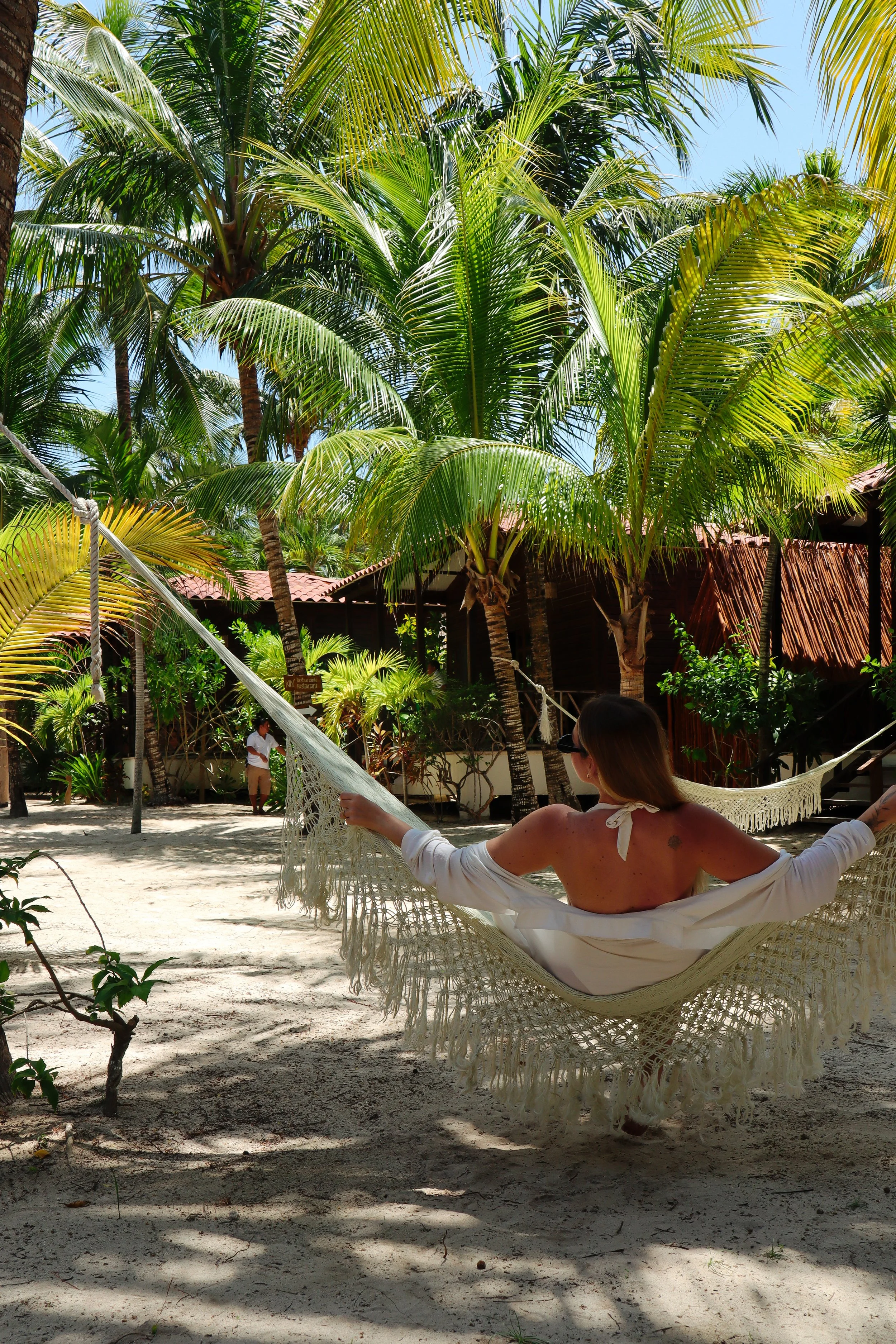Relaxing in a hammock surrounded by lush tropical gardens