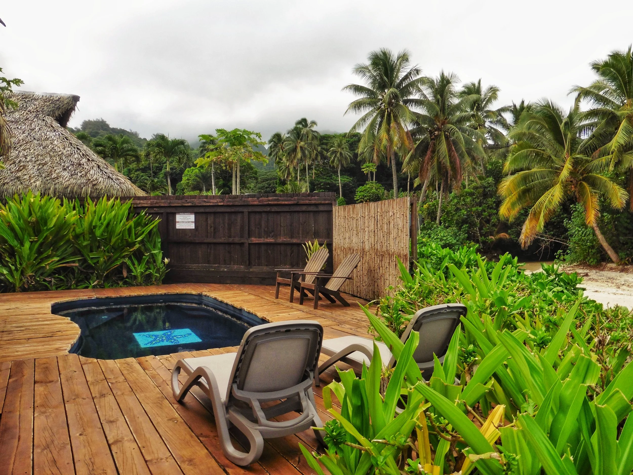 Private beachfront plunge pool surrounded by tropical gardens at Sea Change Villas, Cook Islands