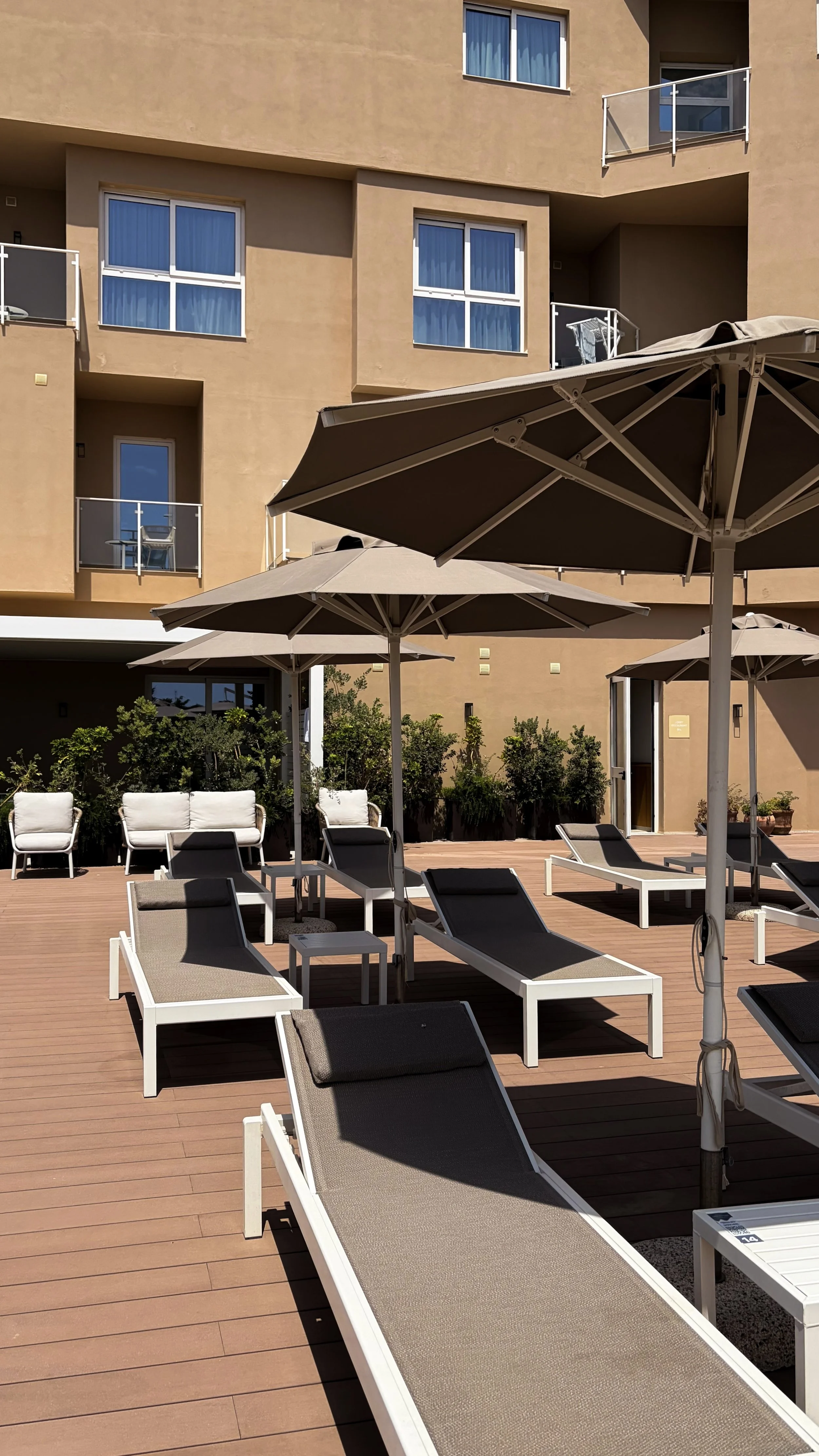 Comfortable sun loungers surrounding the resort's peaceful outdoor pool terrace