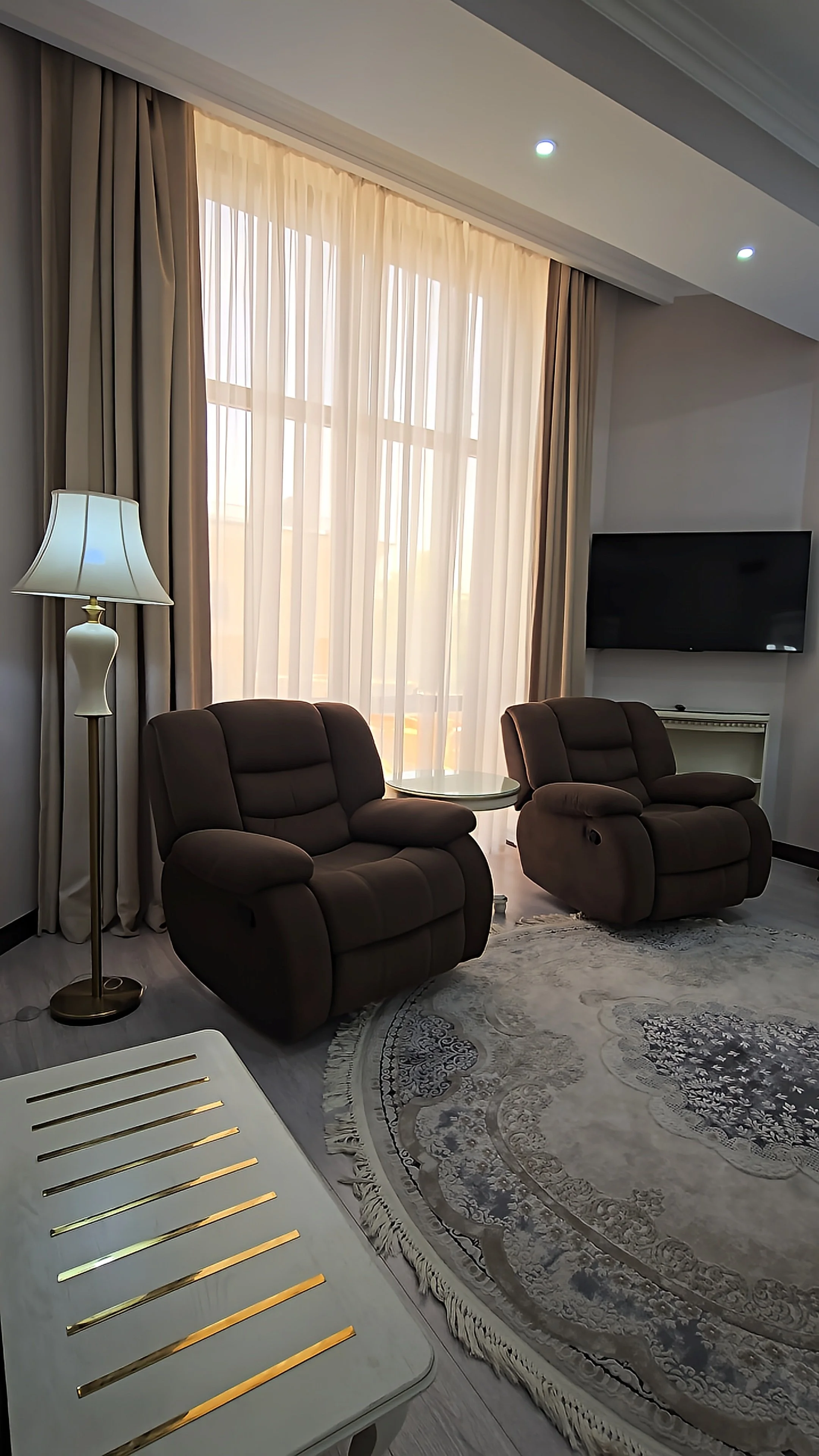 Comfortable lounge area with reclining armchairs, soft natural light, and a relaxing atmosphere
