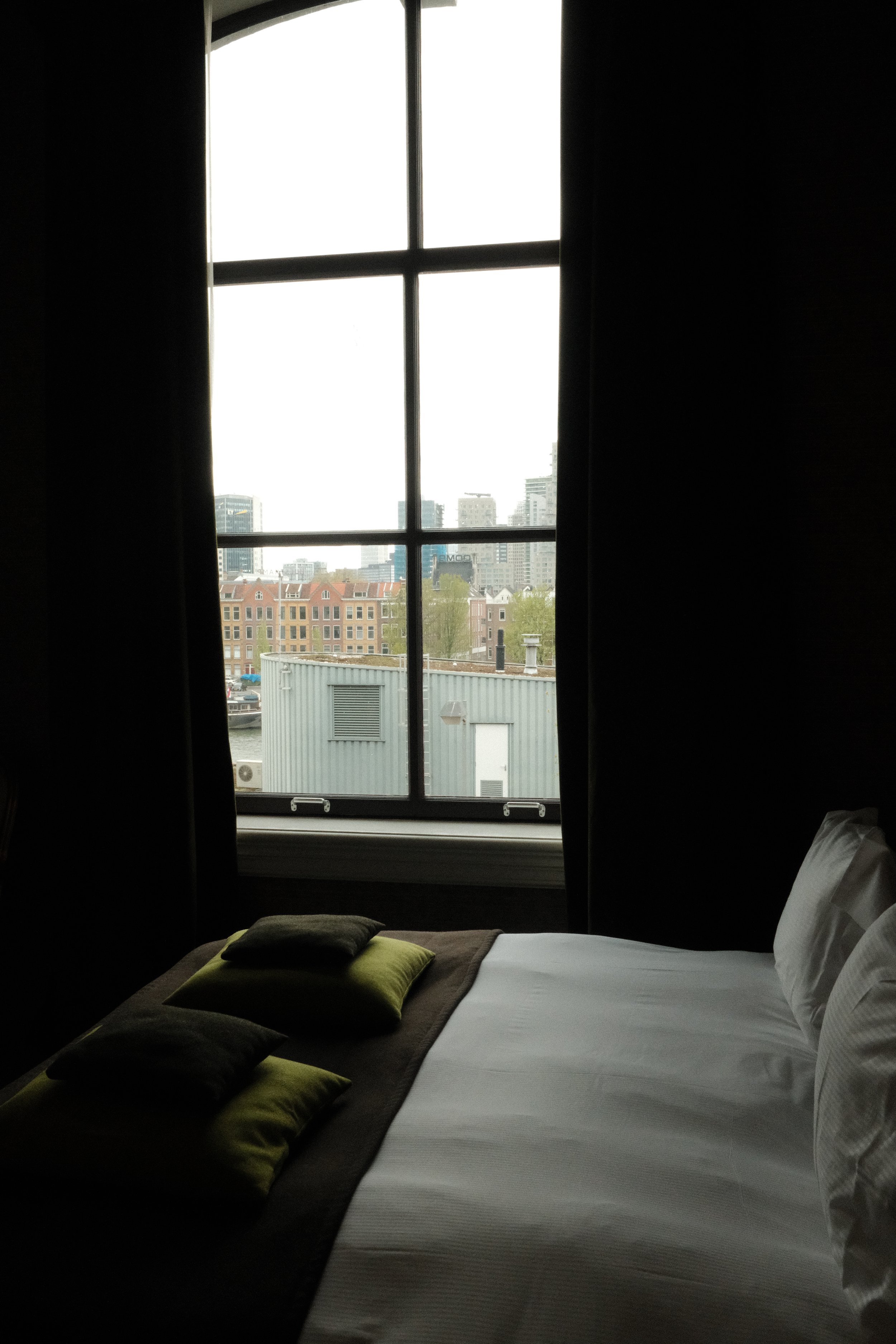 Boutique hotel bedroom with large window and city views at Suite Hotel Pincoffs Rotterdam