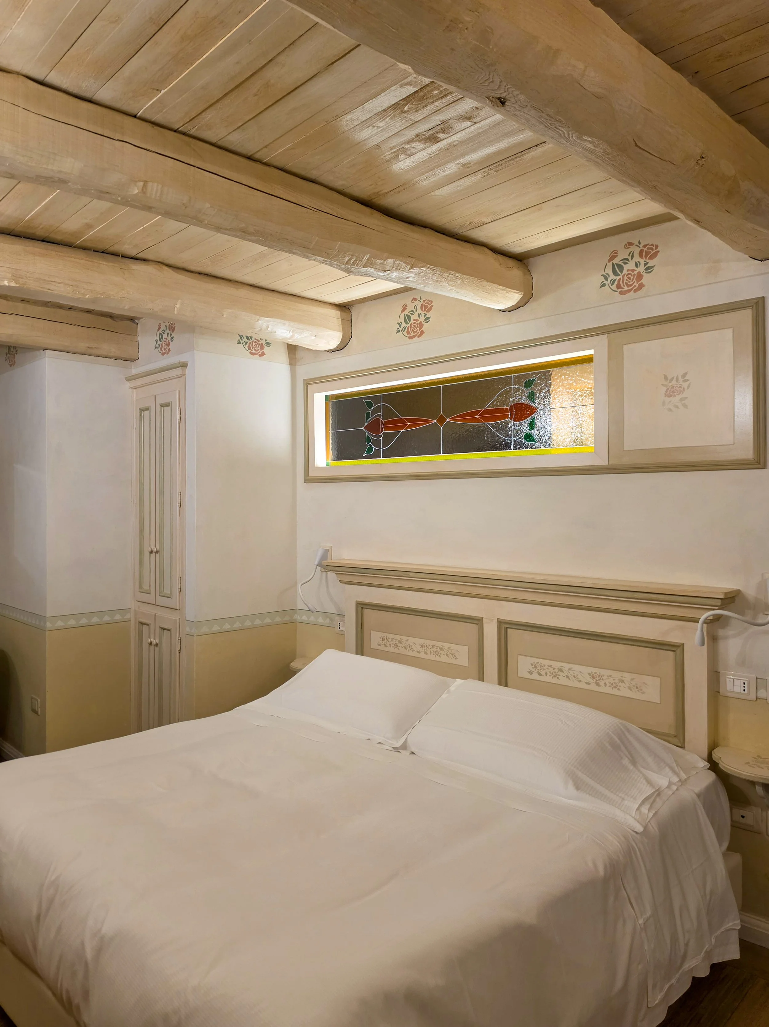 Traditional bedroom with exposed wooden beams and handcrafted decorative details