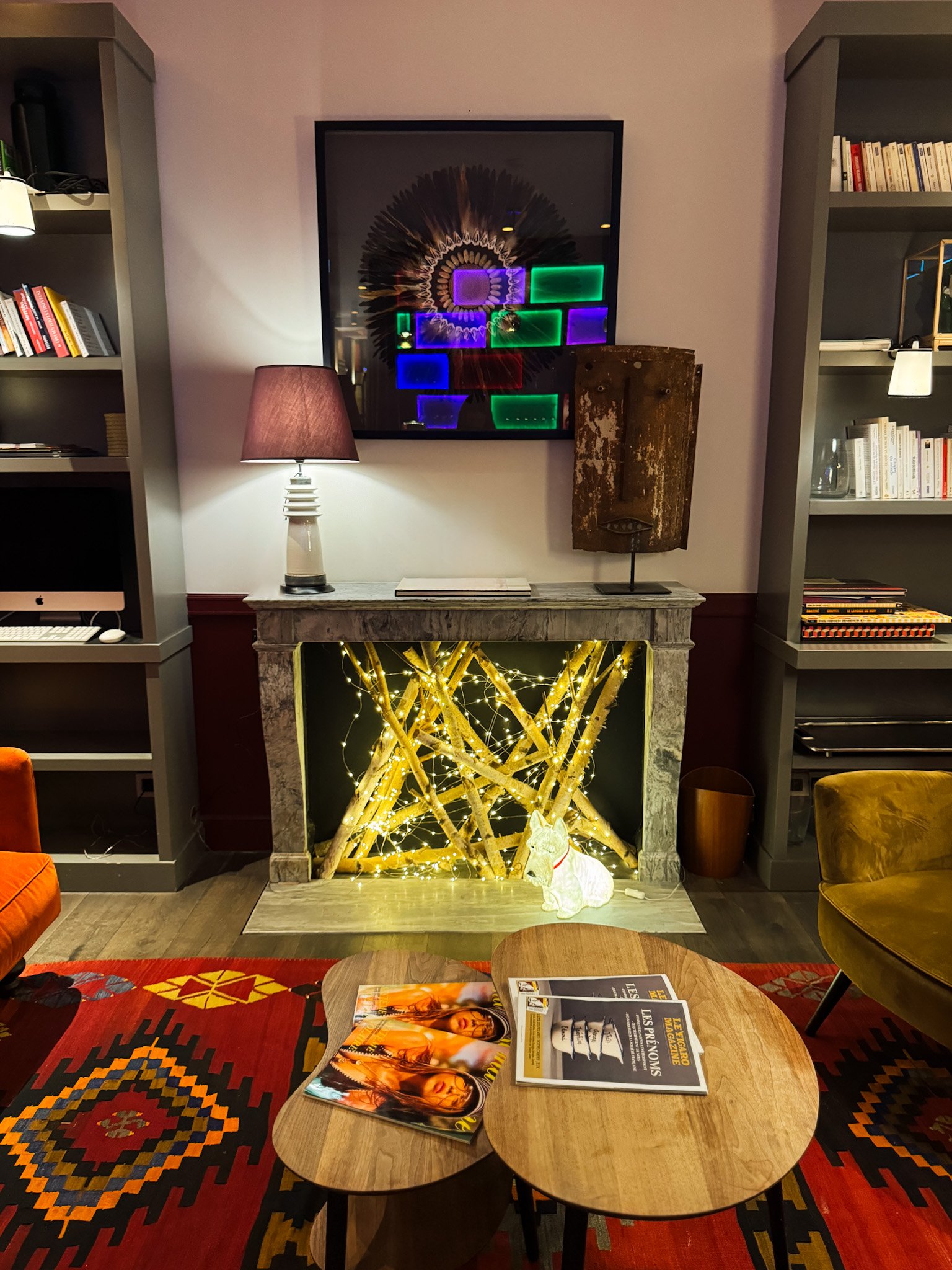 Stylish fireplace lounge decorated with artwork, books, and contemporary furnishings