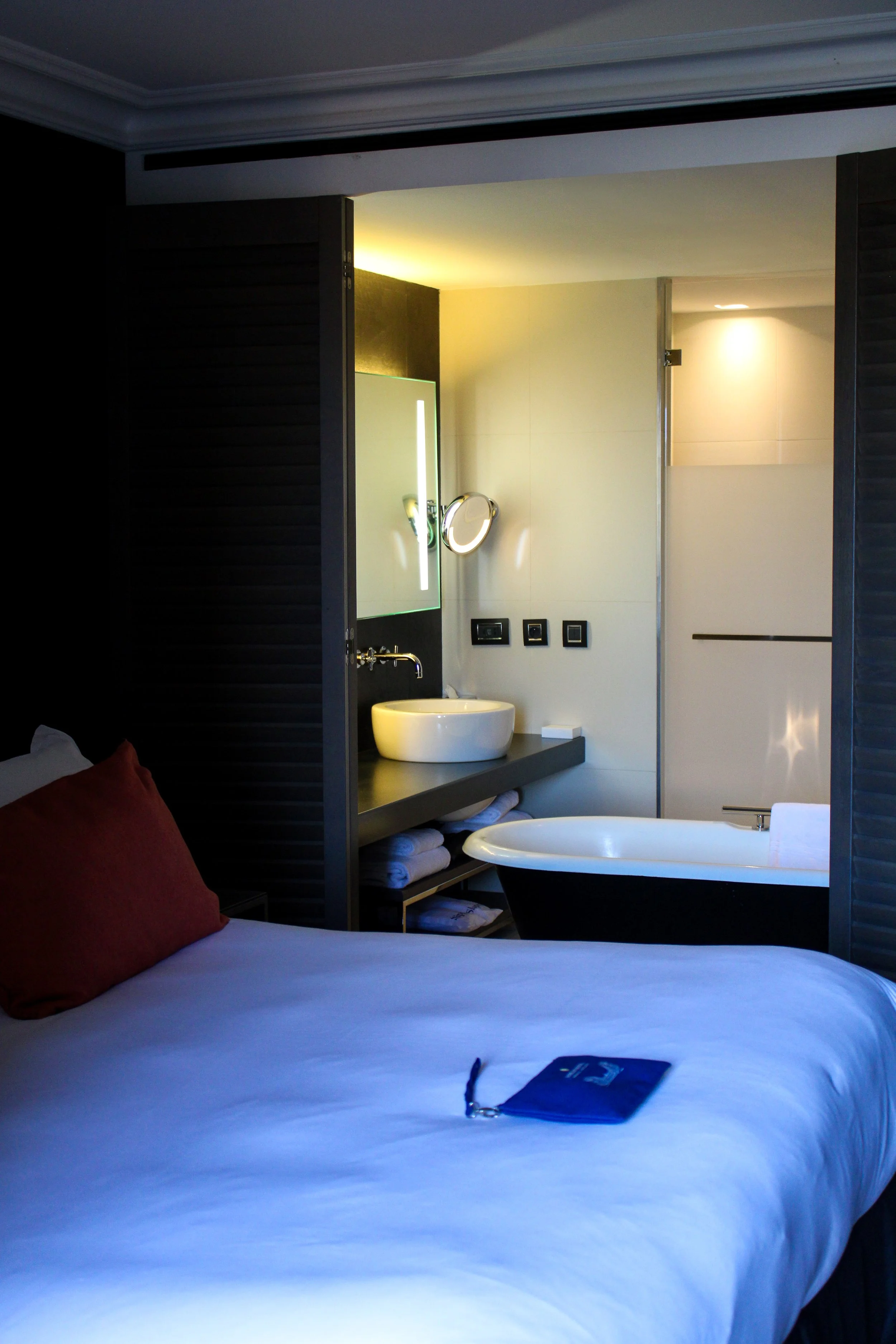 Contemporary guest room with freestanding bathtub and open bathroom design