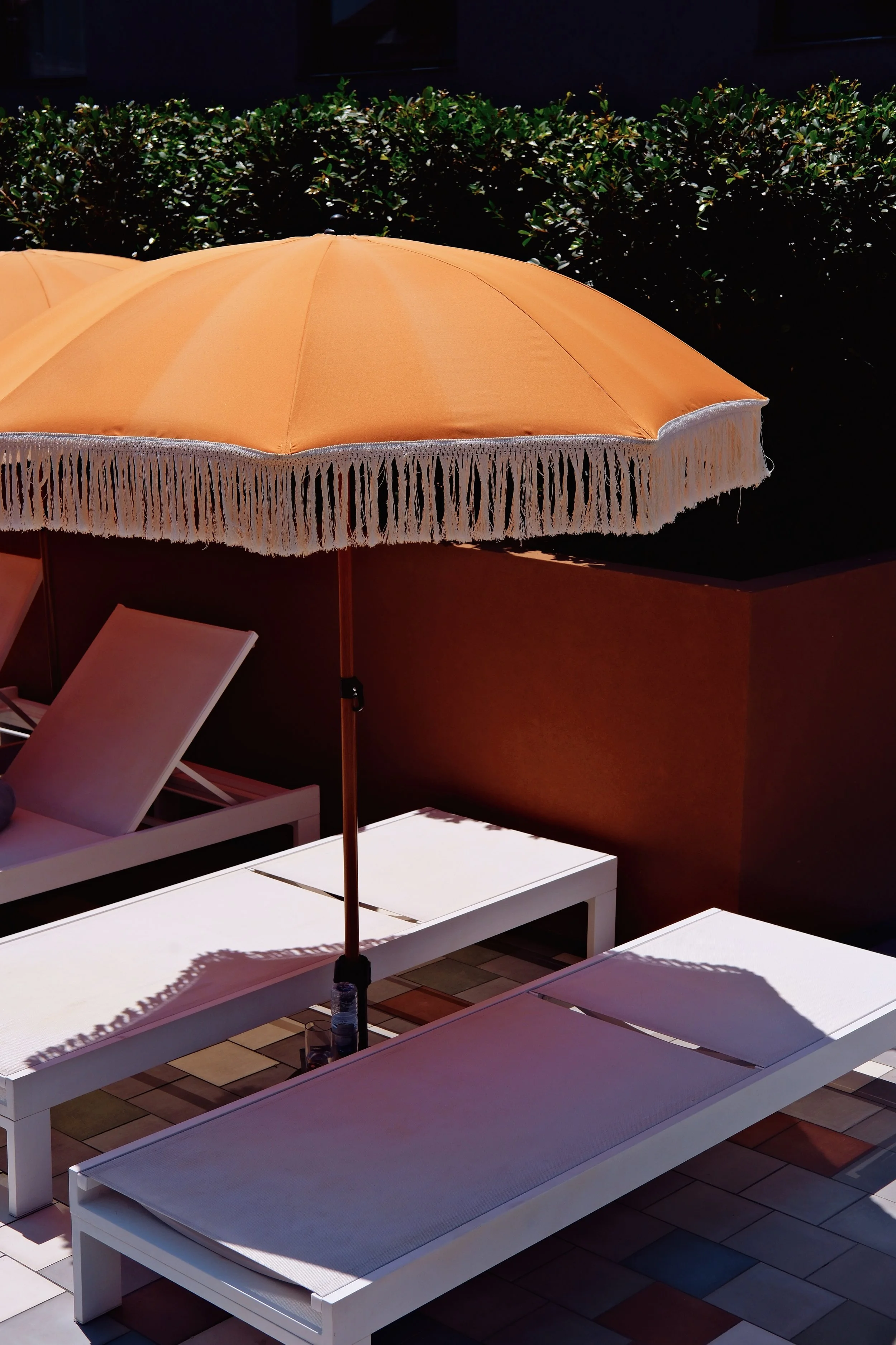 Sun loungers beside the rooftop pool designed for relaxation in Porto