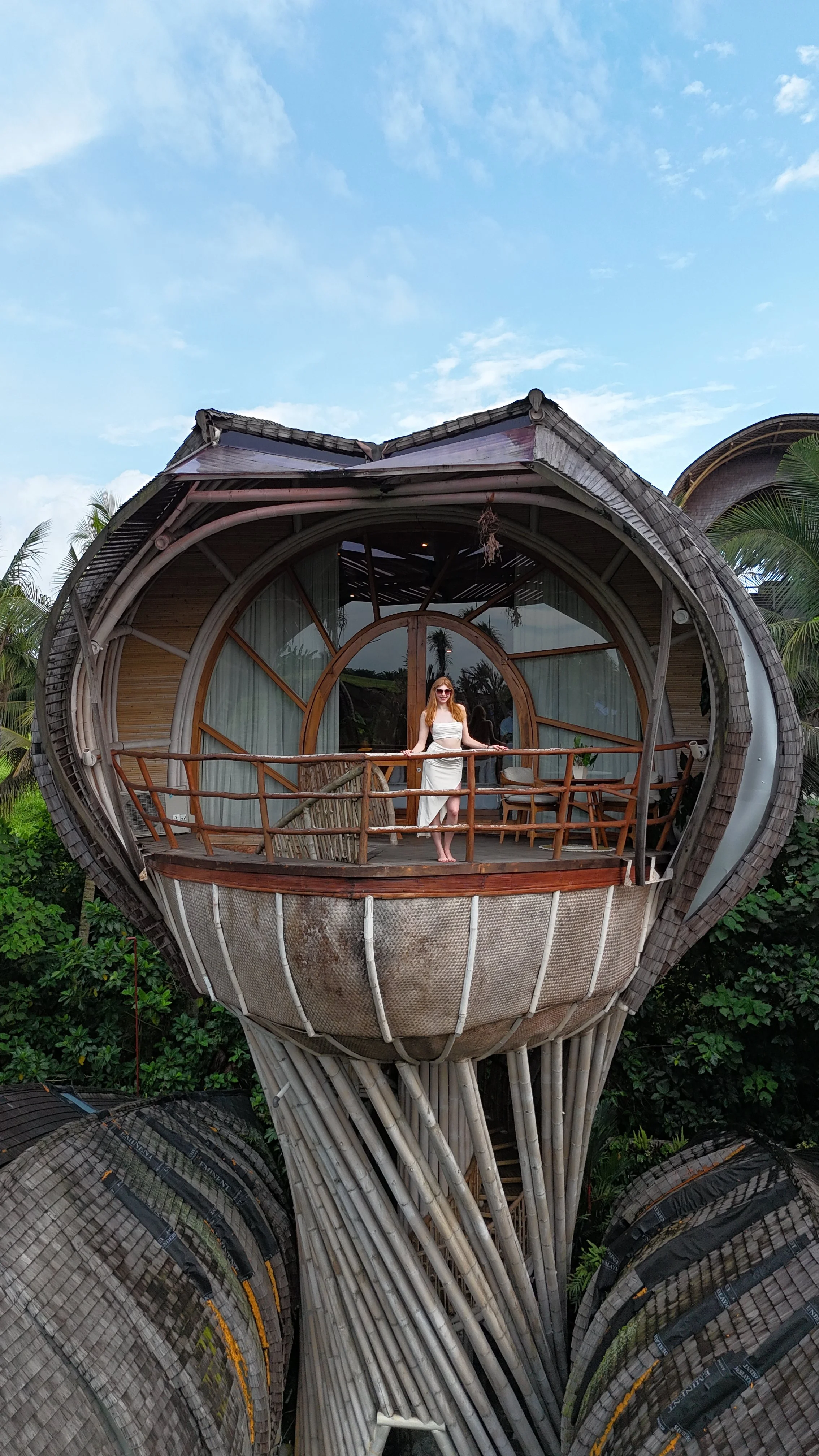An elevated bamboo villa with a private terrace showcases the resort’s distinctive organic architecture surrounded by tropical greenery