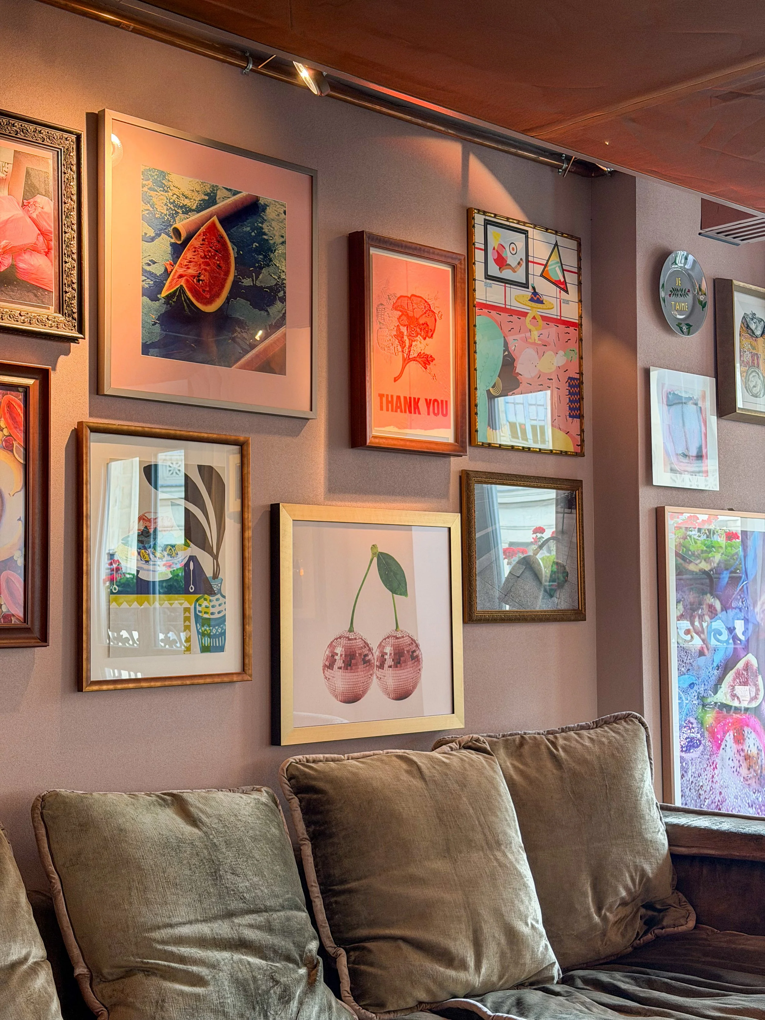 Eclectic lounge with curated gallery wall and comfortable designer seating