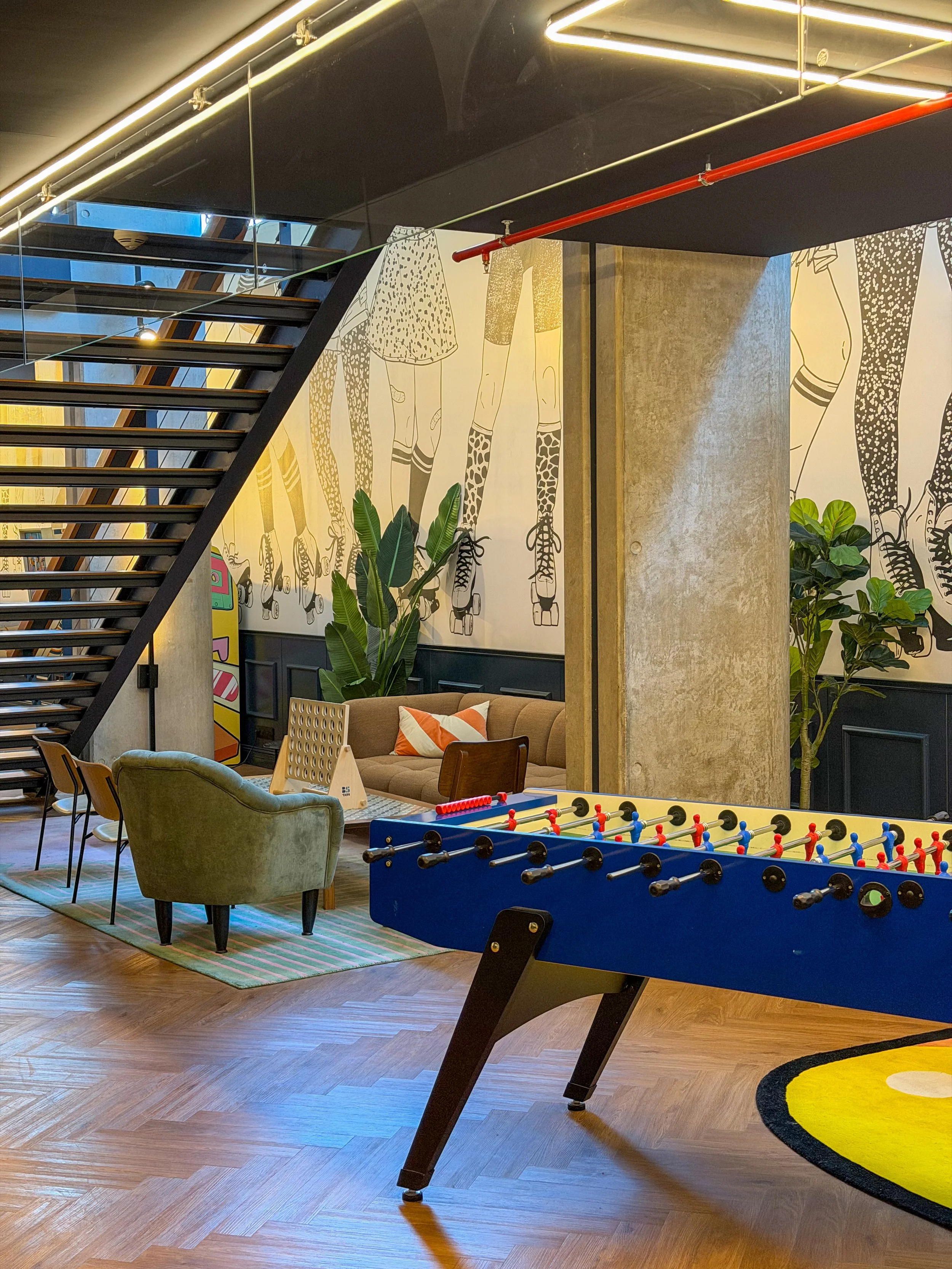 Modern social hub with foosball, lounge seating, and industrial-inspired interiors