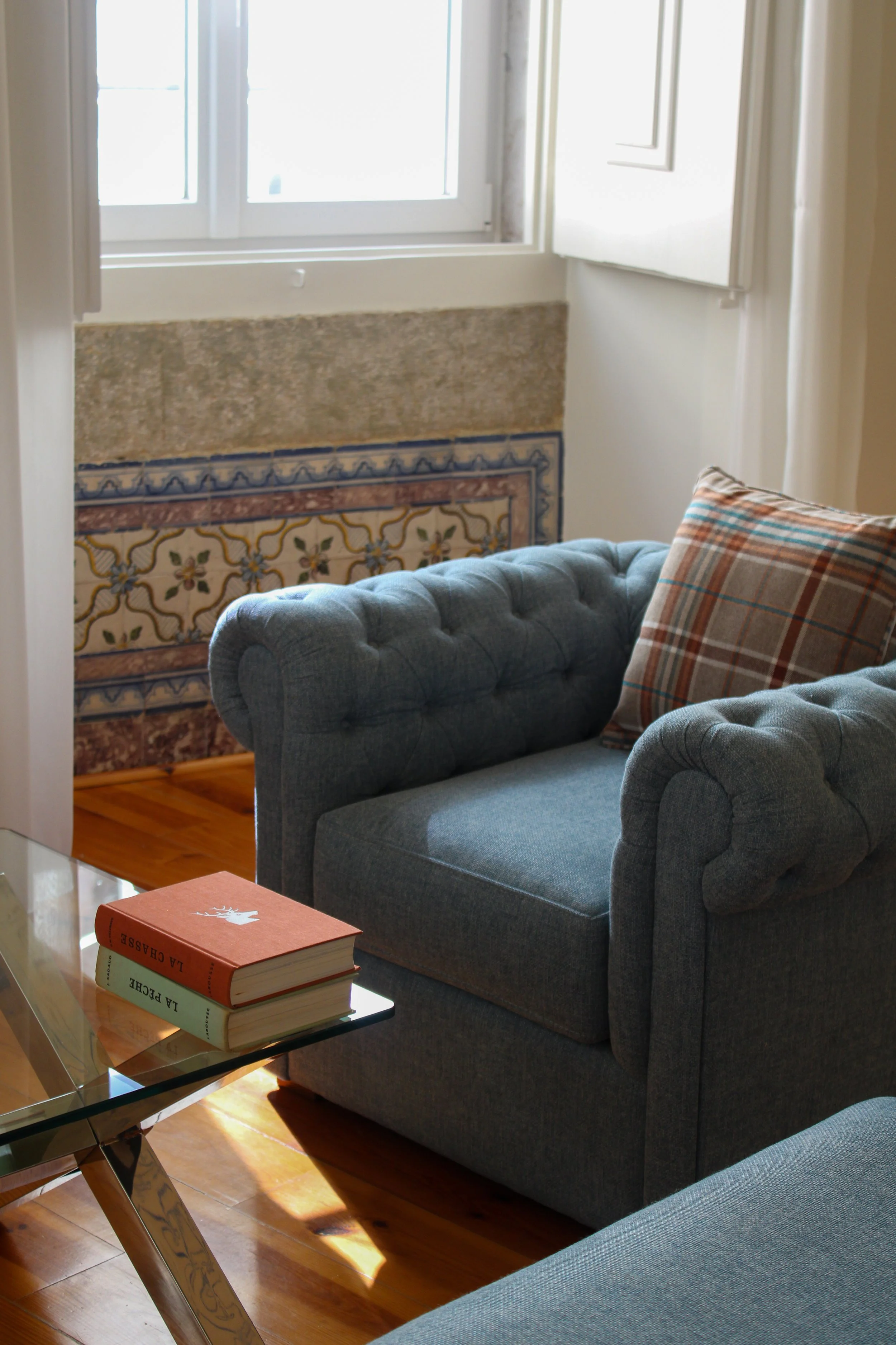 Cozy lounge bedroom corner featuring classic Portuguese design details and natural light at Once Upon Lisboa