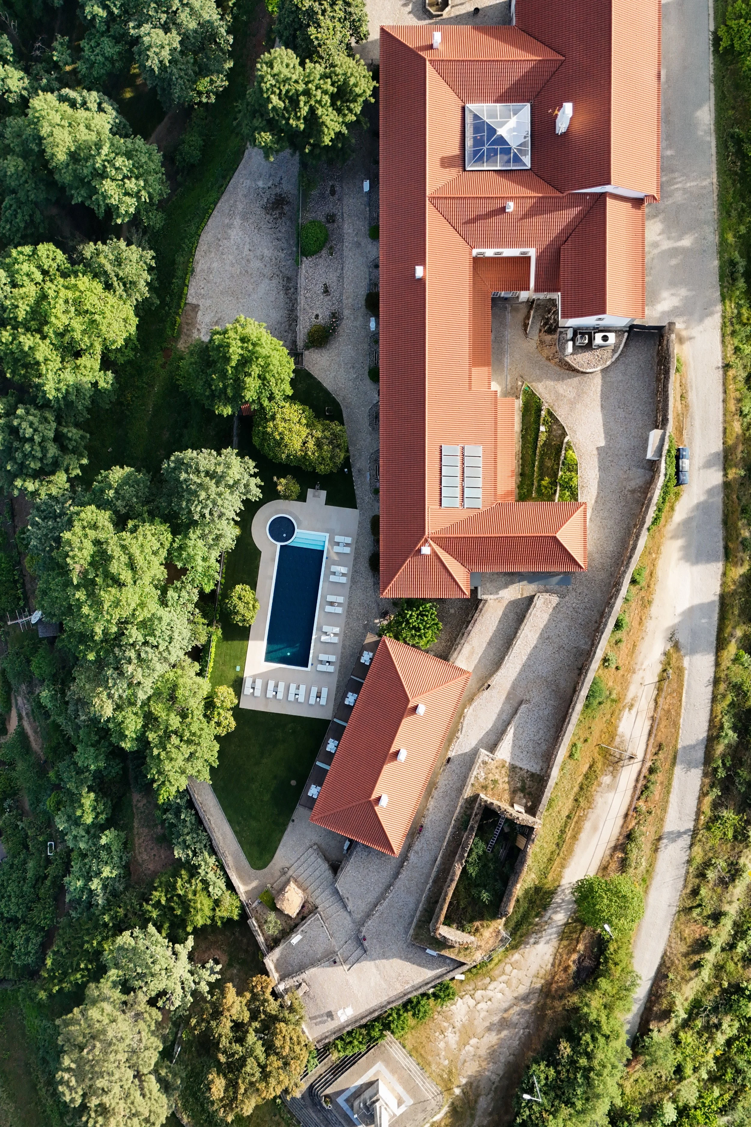 Aerial view of Convento do Seixo surrounded by gardens and pool in Serra da Gardunha, Portugal