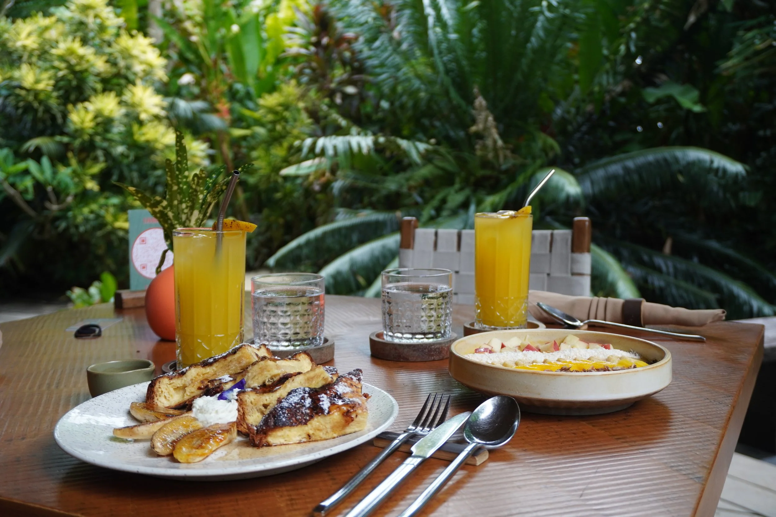 Fresh breakfast spread surrounded by Siargao's vibrant jungle scenery