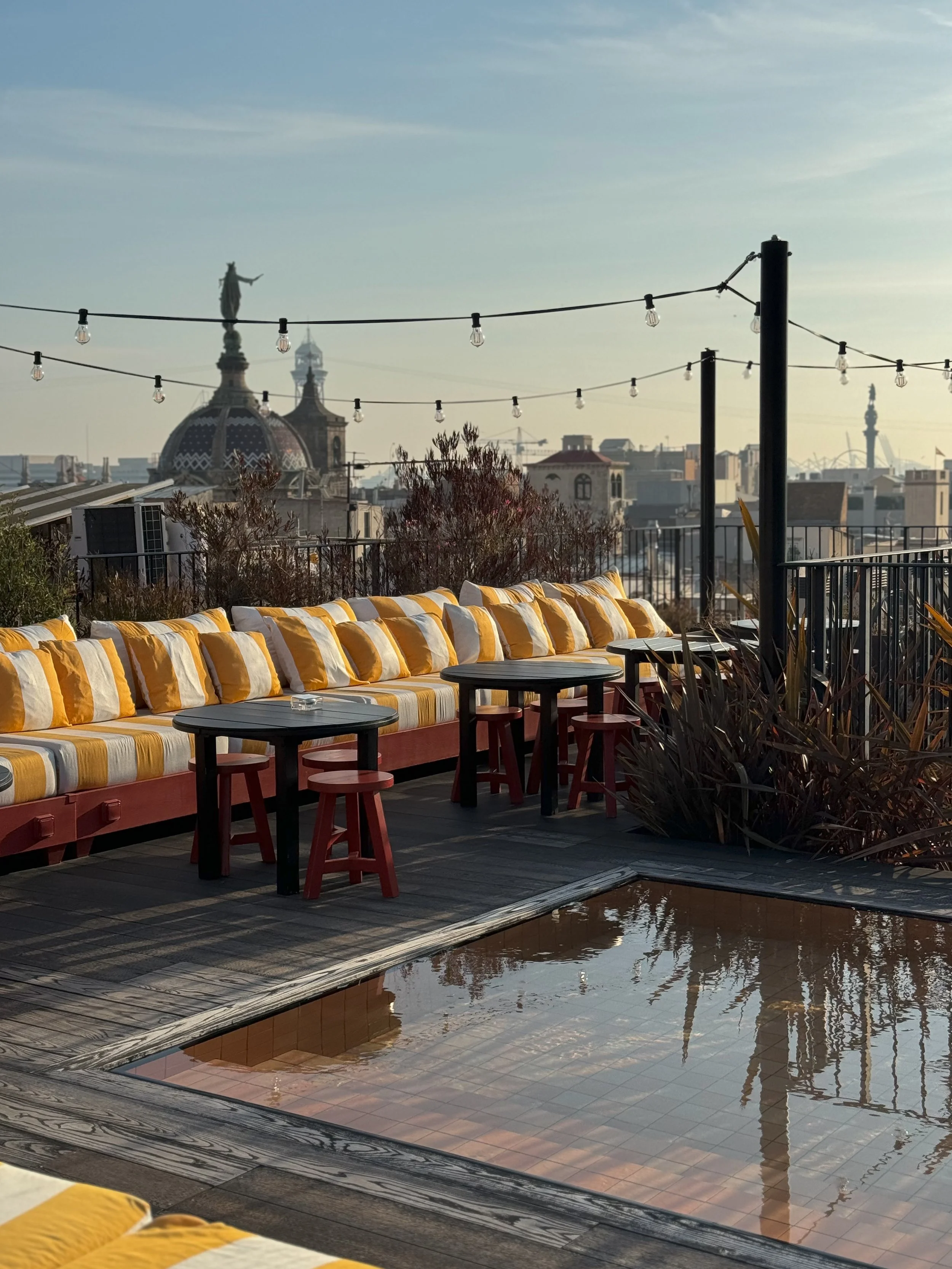 Stylish rooftop terrace with panoramic Barcelona skyline views at Wittmore Hotel