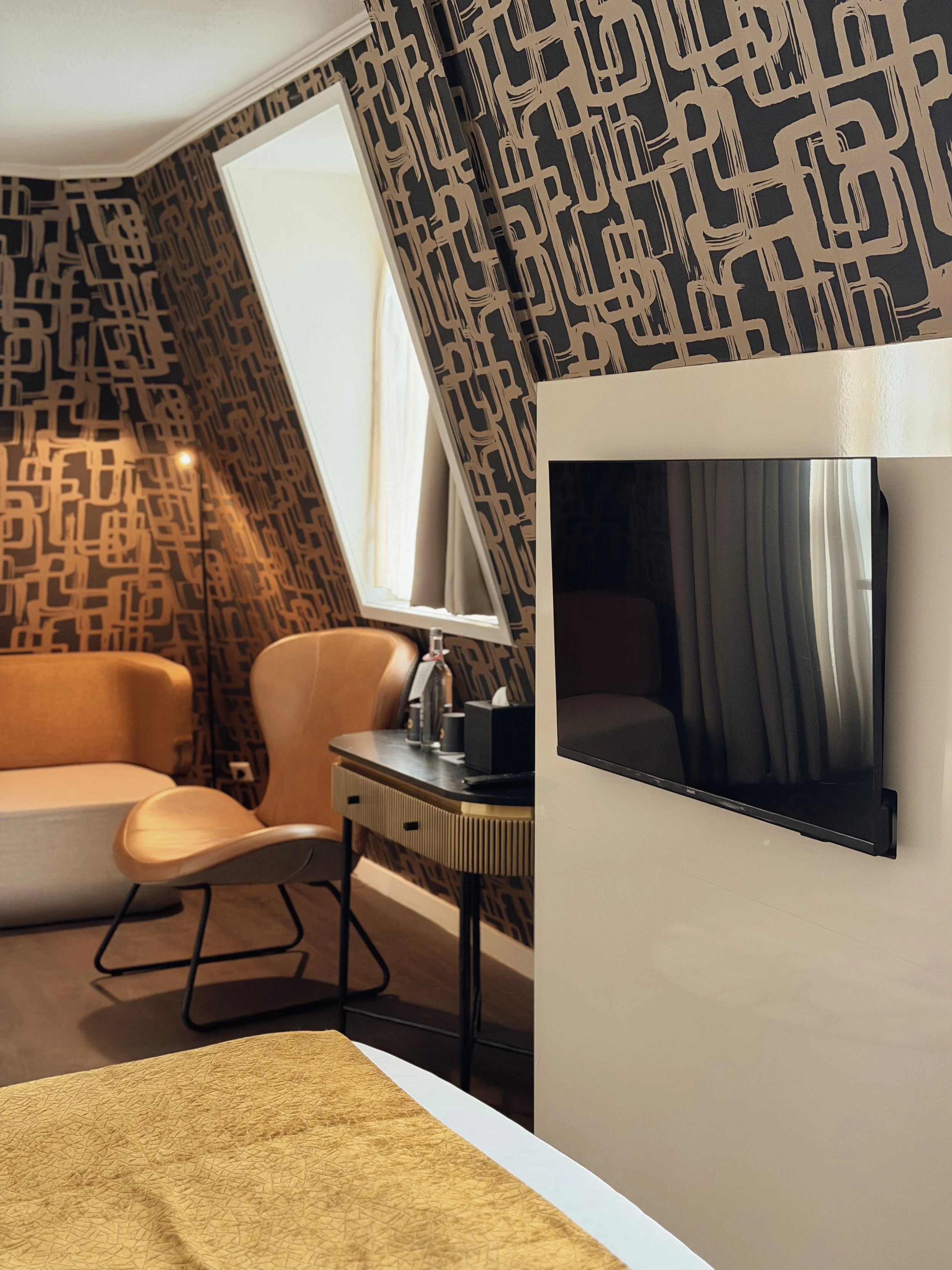 Stylish guest room with designer furnishings and modern workspace