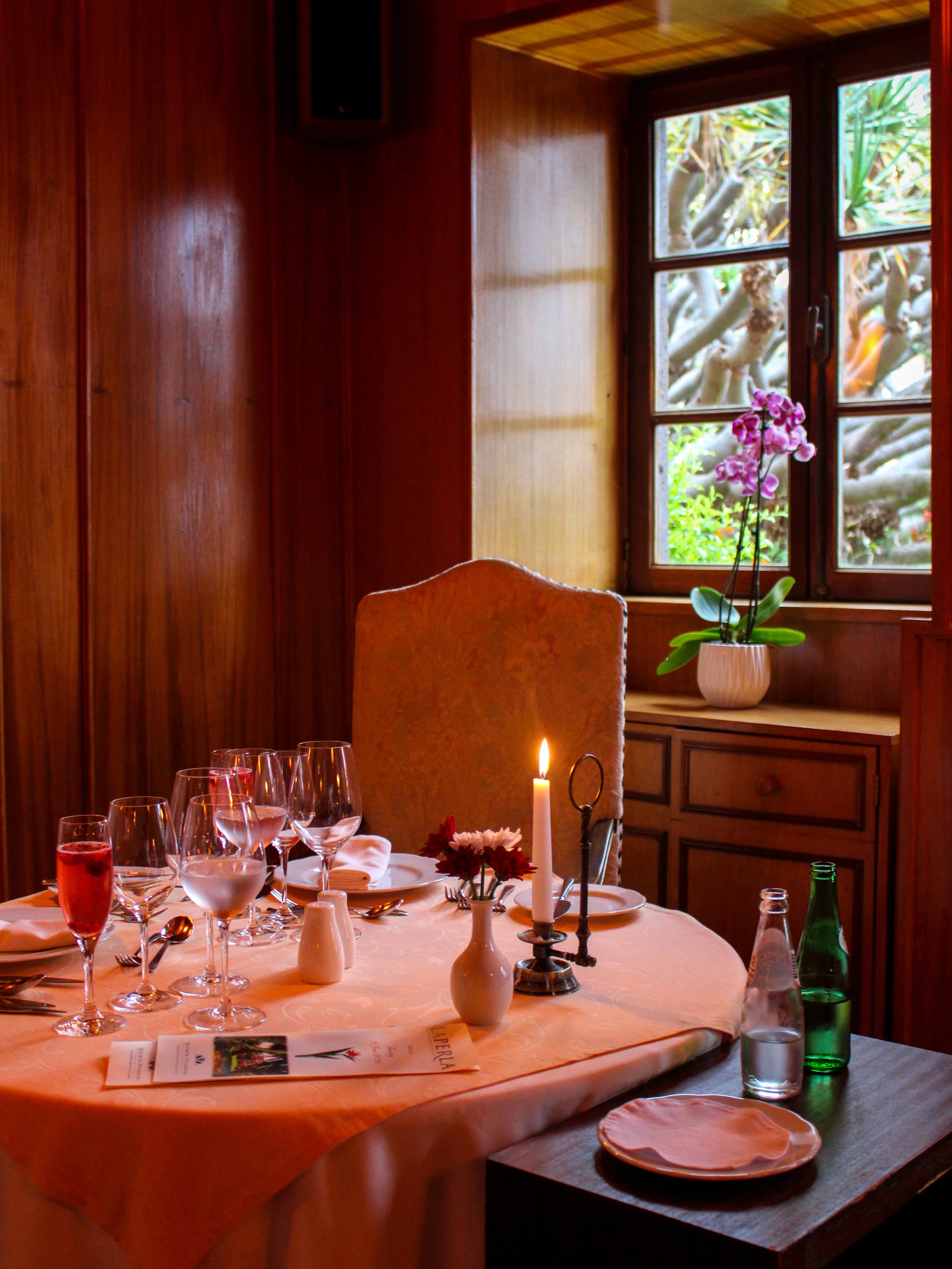 Intimate fine dining experience with candlelight, refined table setting, and gourmet cuisine