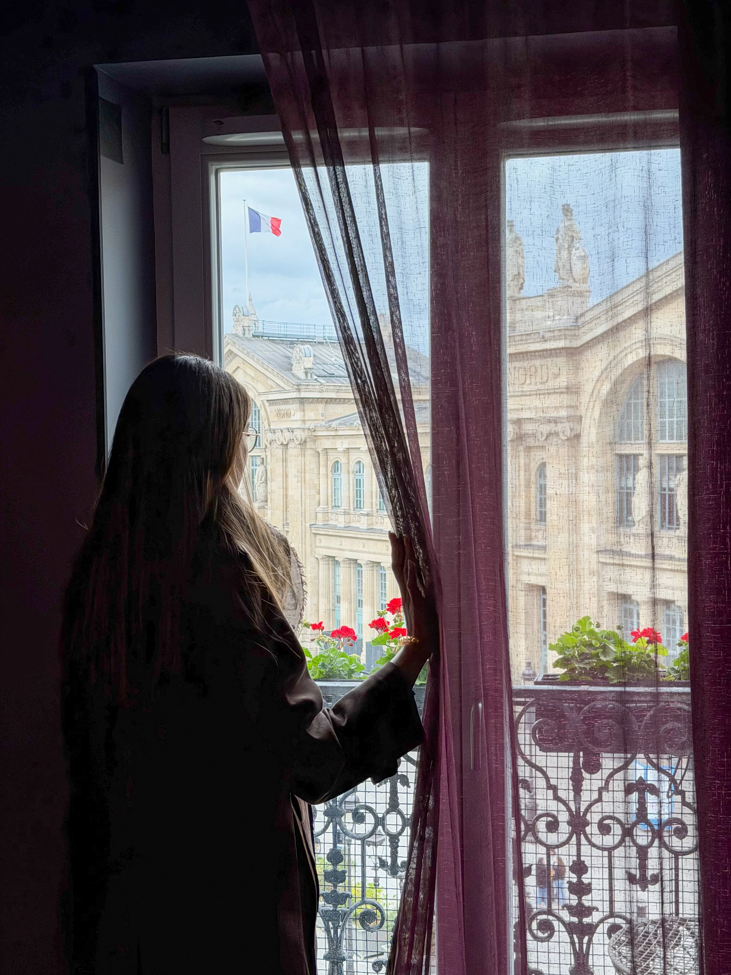 Guest room overlooking Gare du Nord with a classic Parisian balcony view