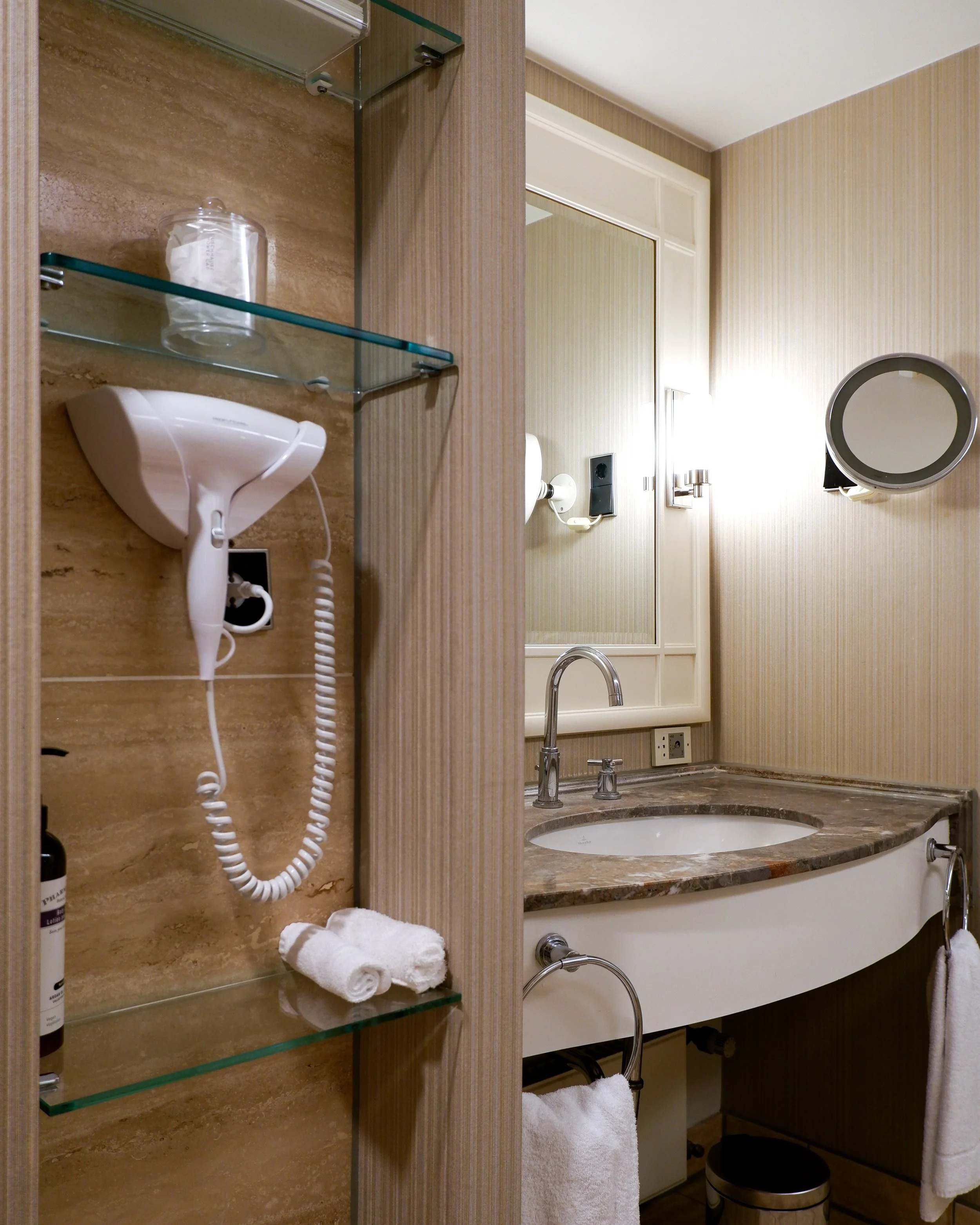 Modern marble bathroom with premium amenities, spacious vanity, and elegant contemporary finishes
