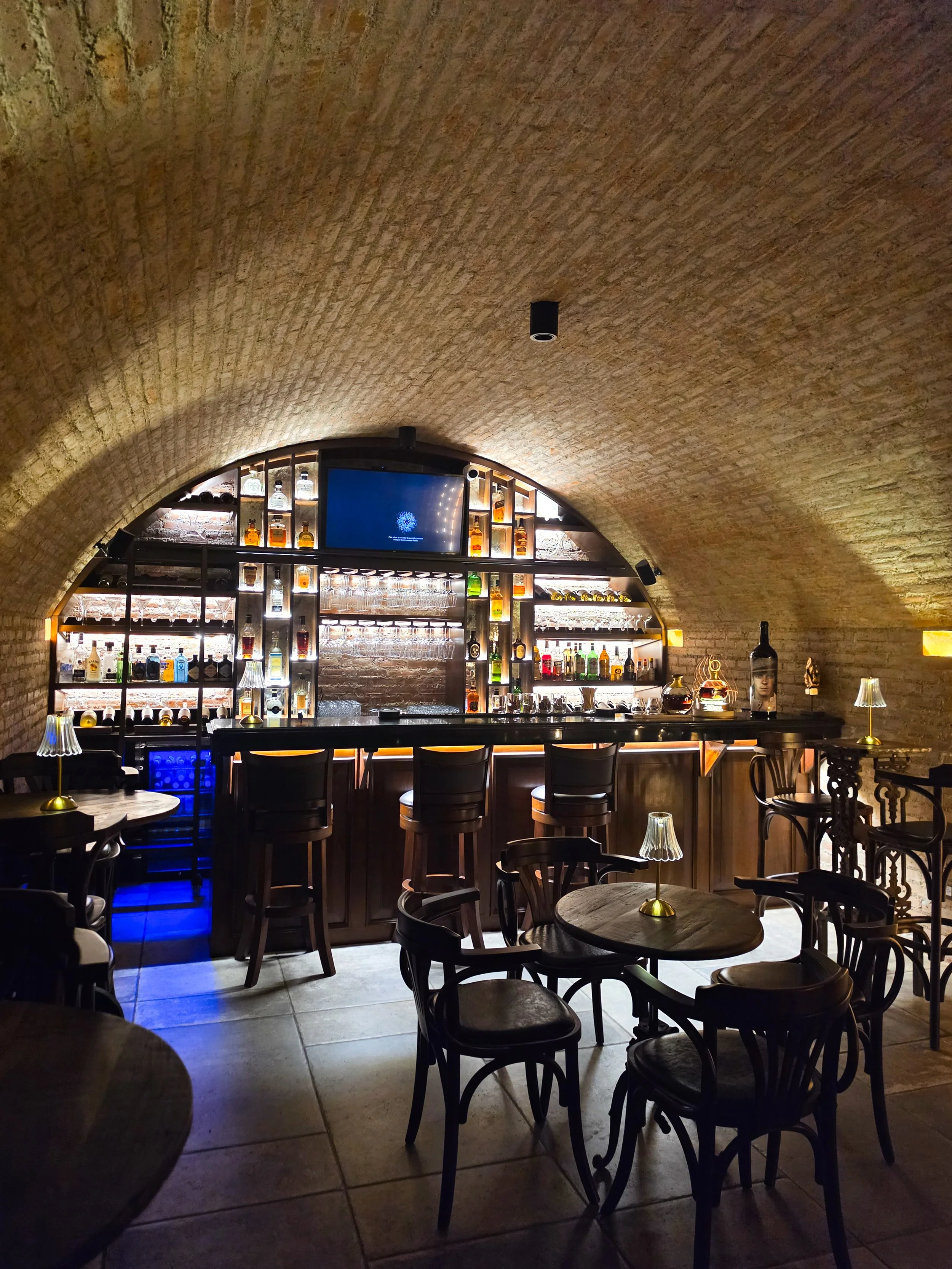 Intimate underground cocktail bar with exposed brick vaulted ceilings