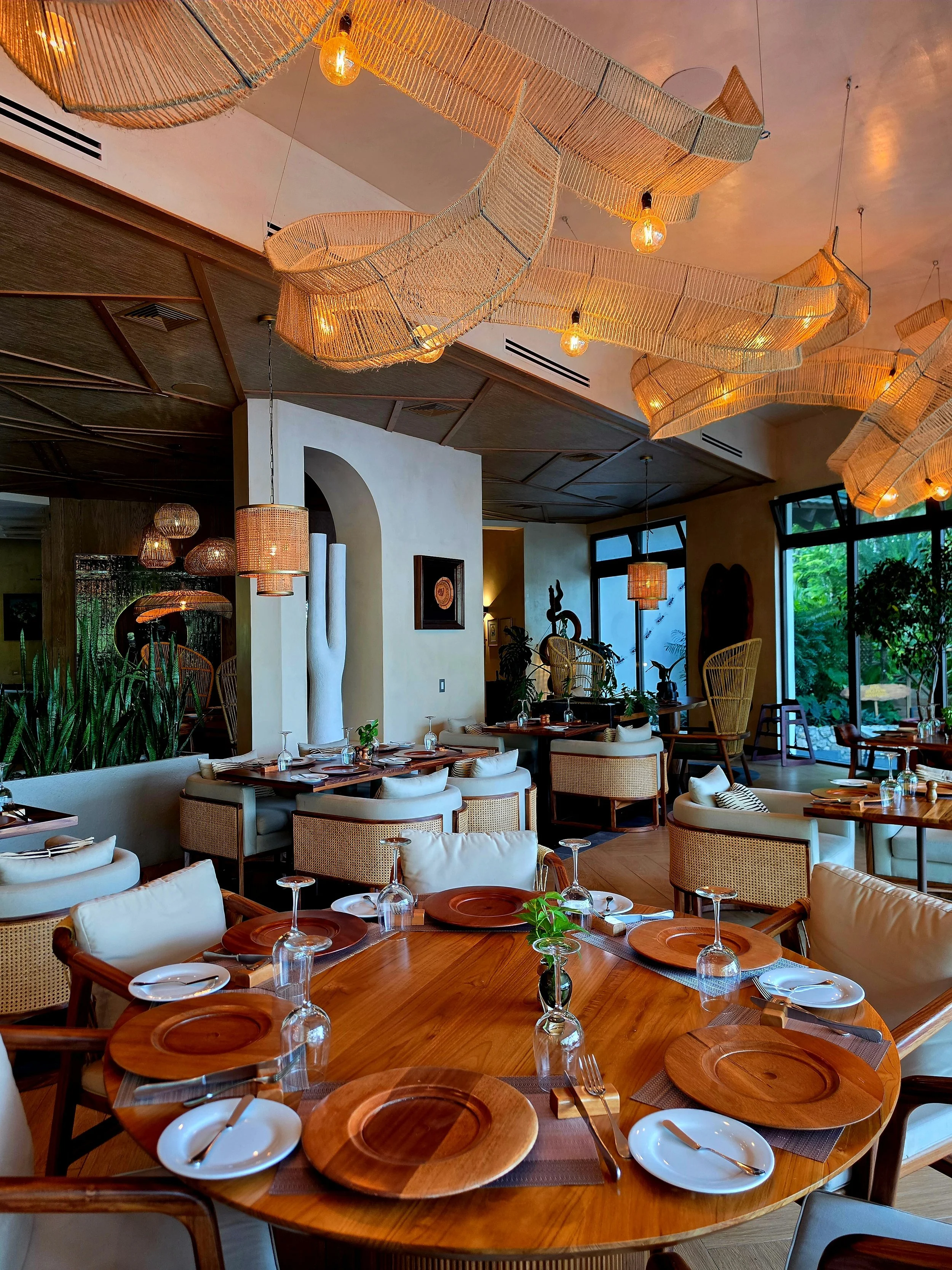 Elegant restaurant serving gourmet cuisine beneath handcrafted woven lighting