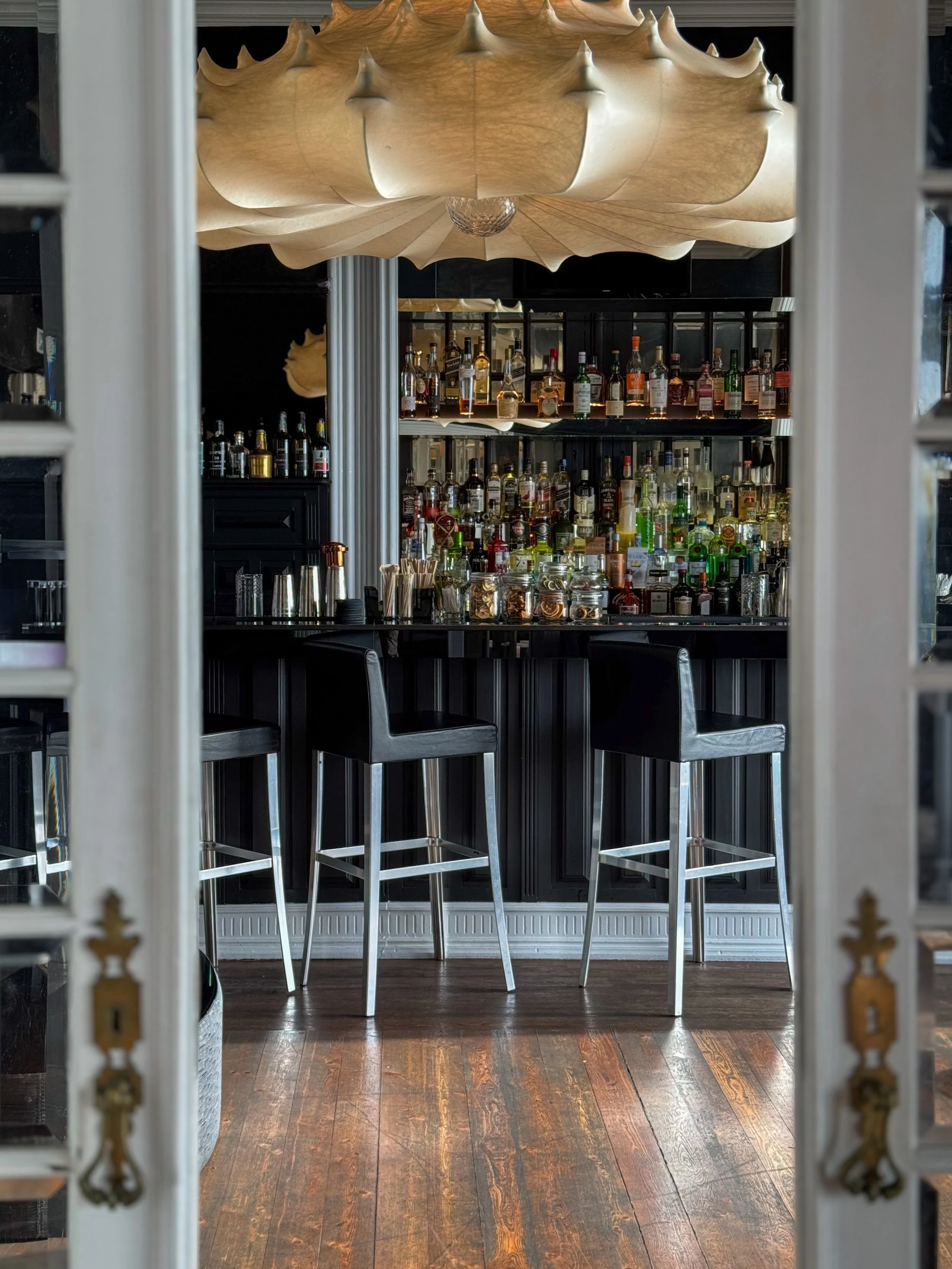 Stylish cocktail bar featuring designer lighting, premium spirits, and elegant interiors