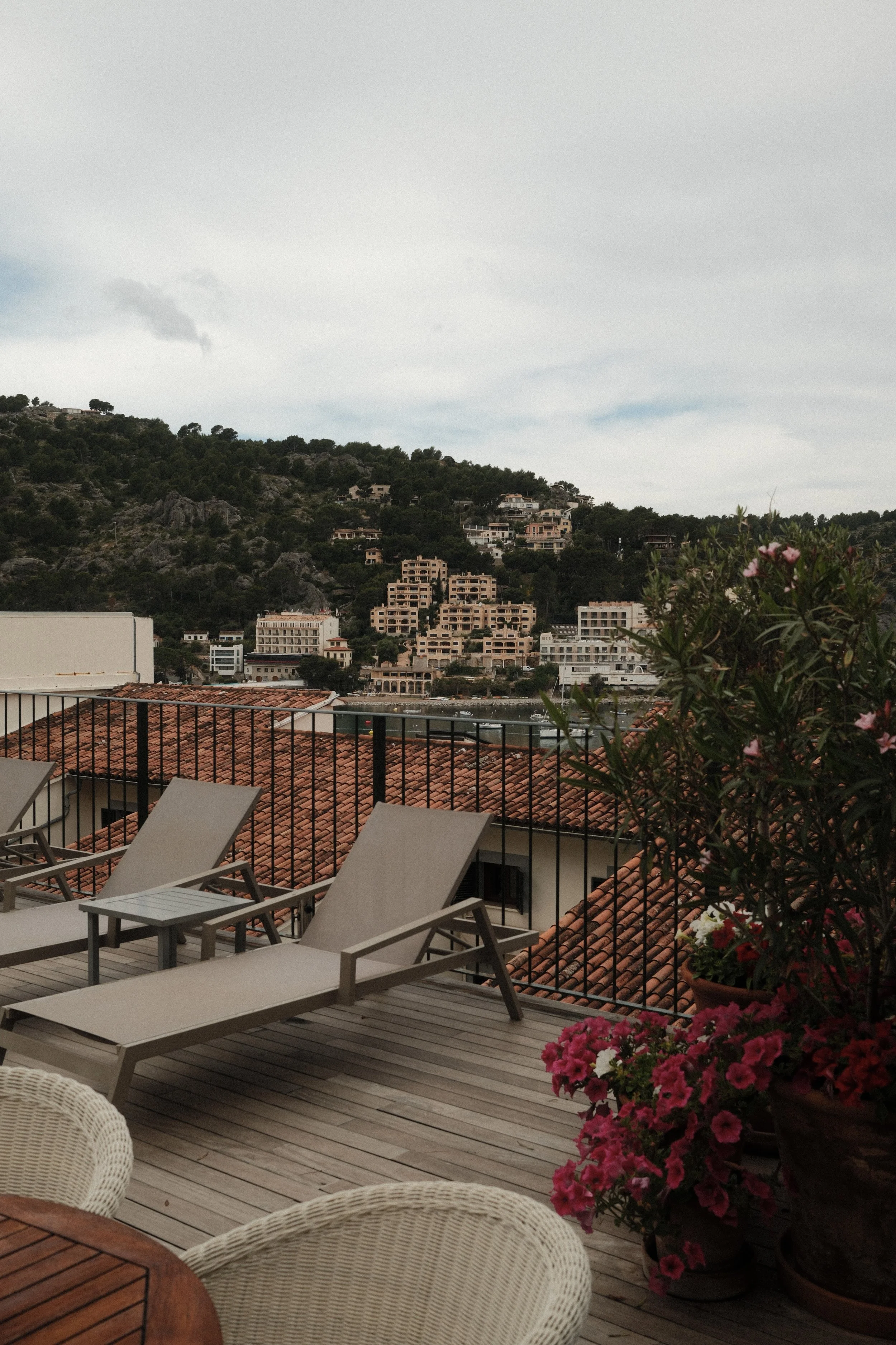 Rooftop sunbeds with views across Port de Sóller at Hotel Espléndido