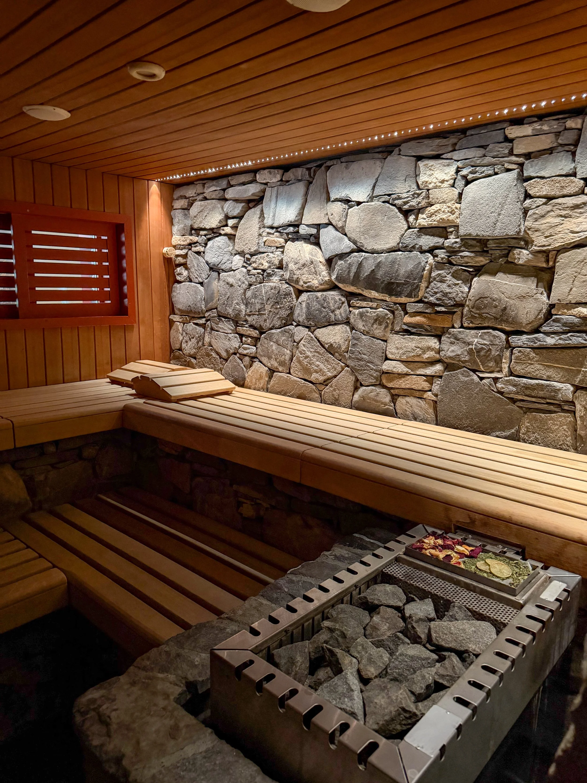 Traditional alpine sauna featuring natural stone walls, timber finishes and wellness facilities at Eiger Mountain & Spa Soul Resort