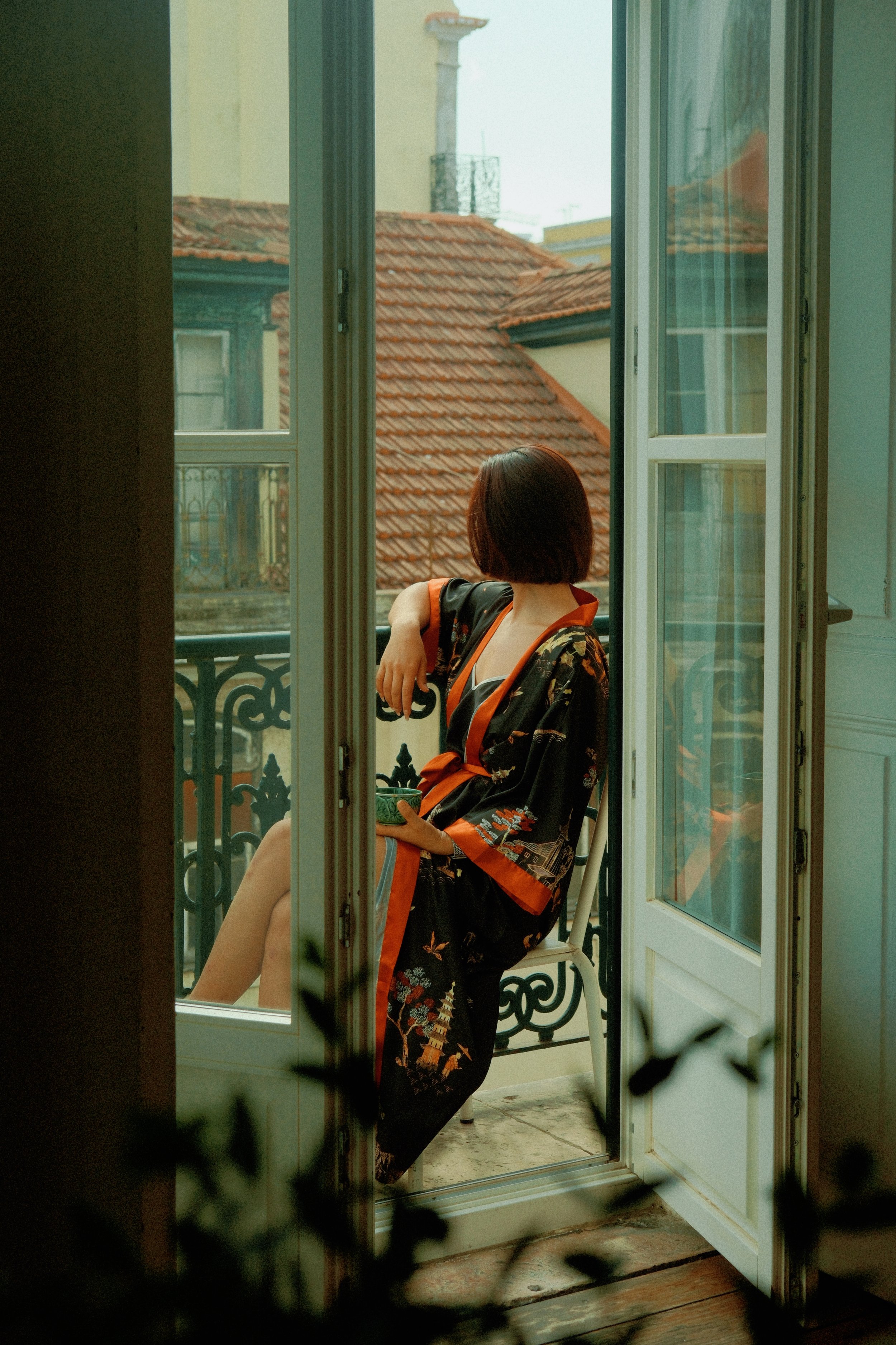 Relaxing morning on a private balcony overlooking the rooftops of Baixa